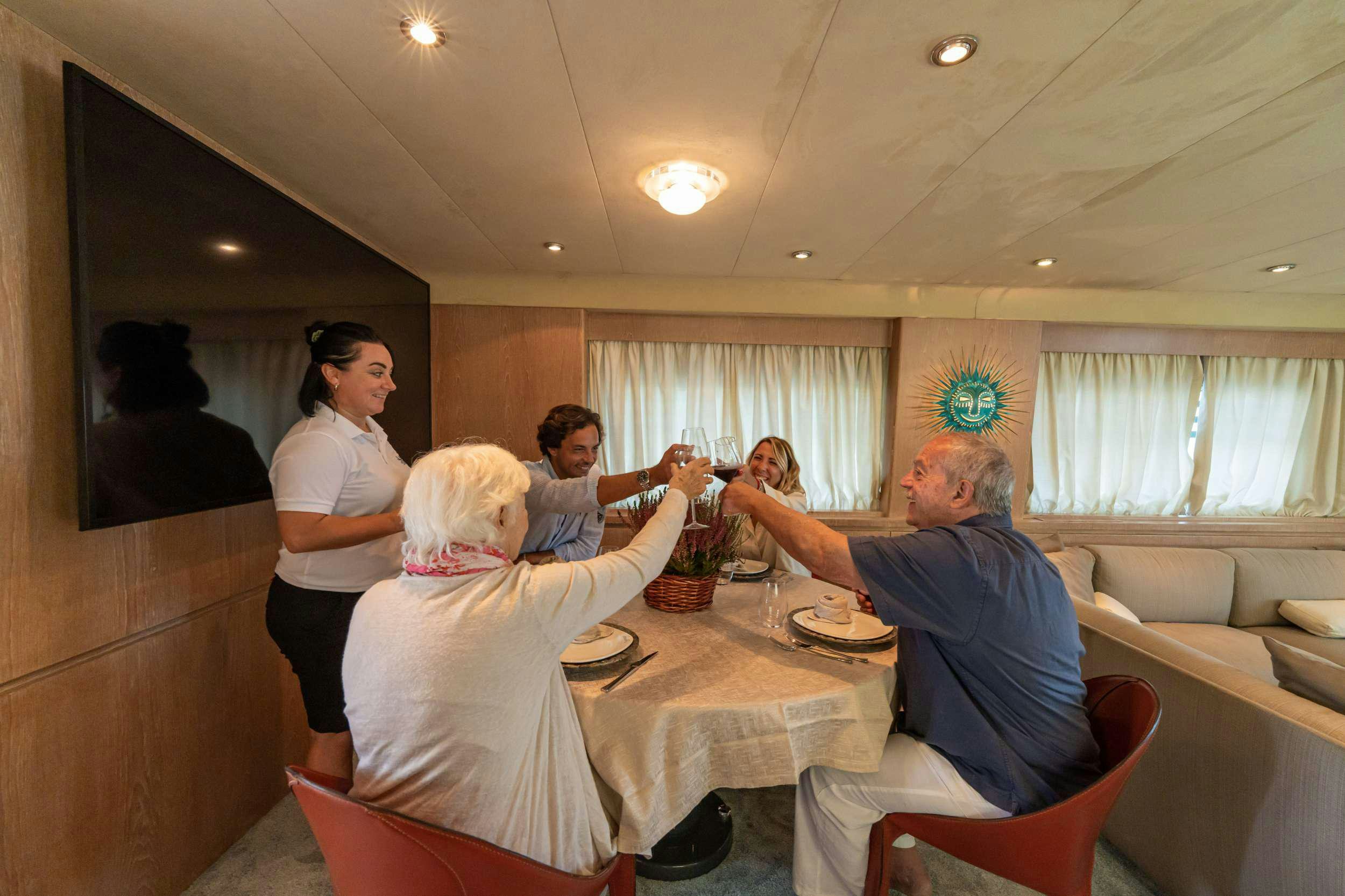 a group of people around a table aboard SANDI IV Yacht for Charter