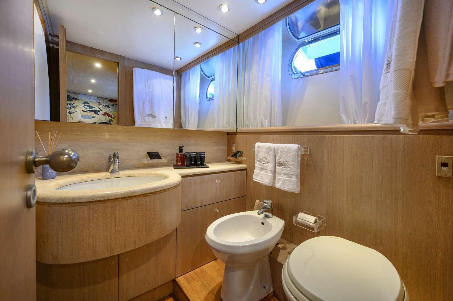a bathroom with a large mirror aboard SANDI IV Yacht for Charter