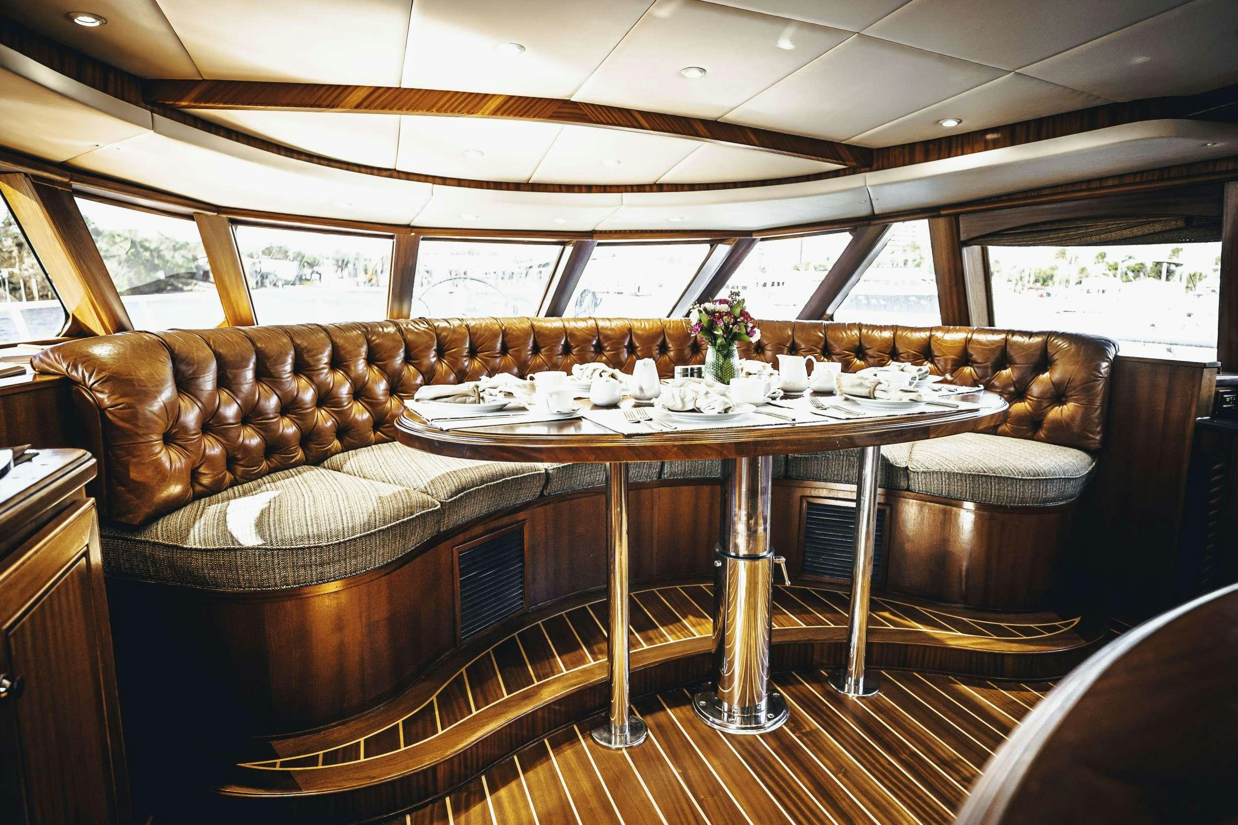 a room with a table and chairs aboard READY II PLAY Yacht for Charter