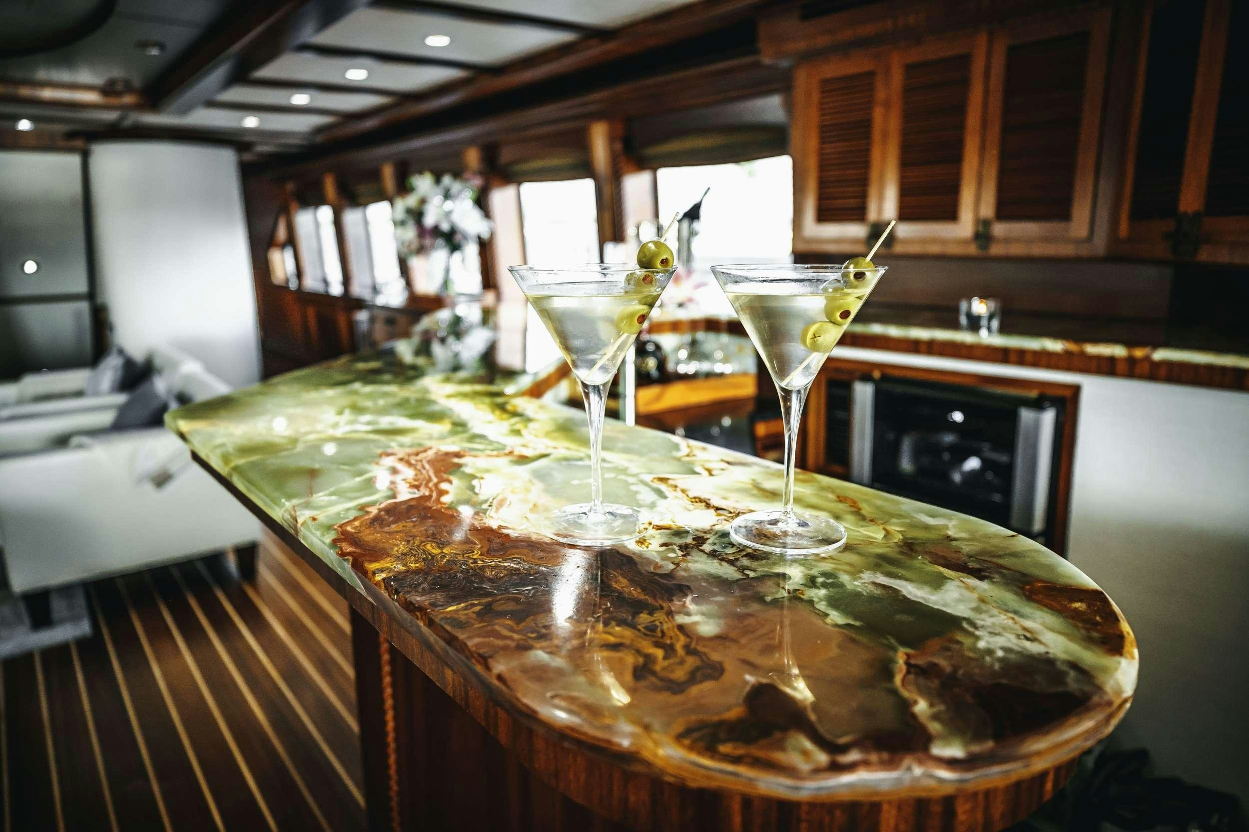 a group of wine glasses on a counter top aboard READY II PLAY Yacht for Charter