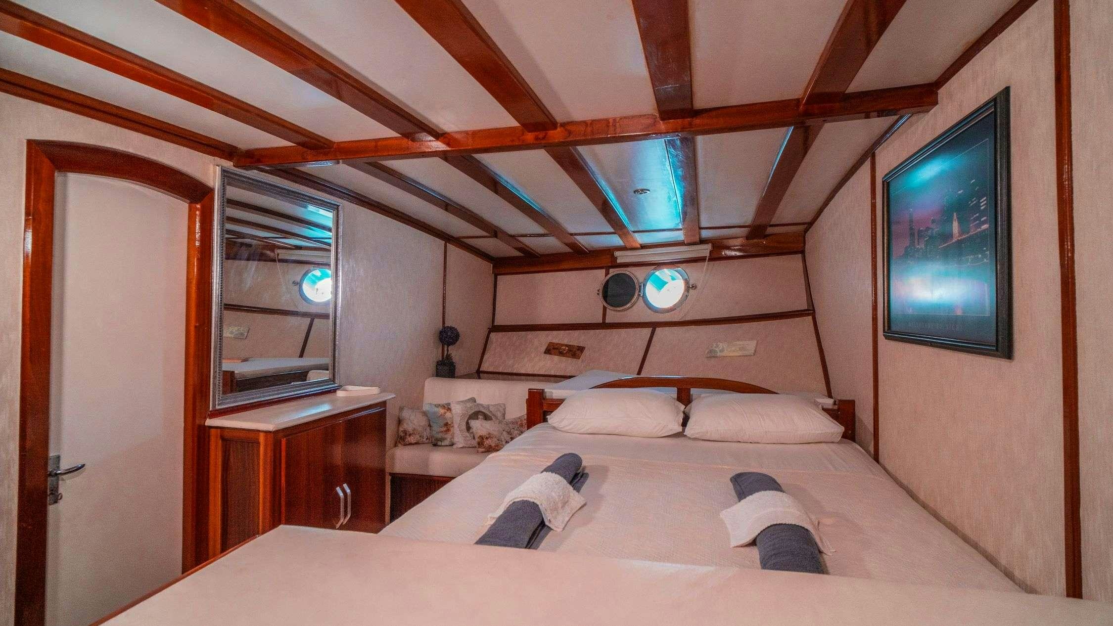 a room with a bed and a tv aboard WHITE SWAN Yacht for Charter