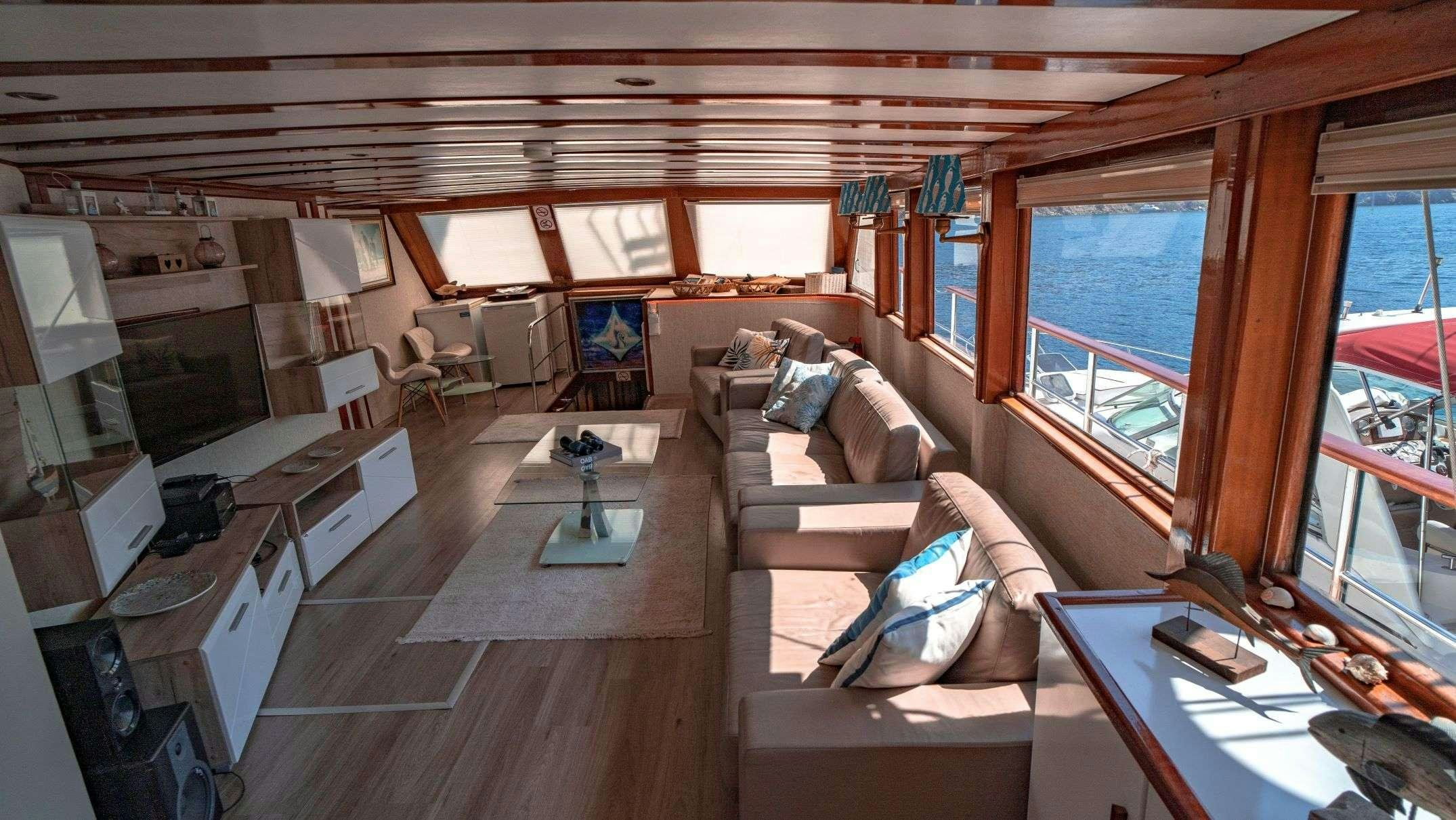 a living room with a large window aboard WHITE SWAN Yacht for Charter