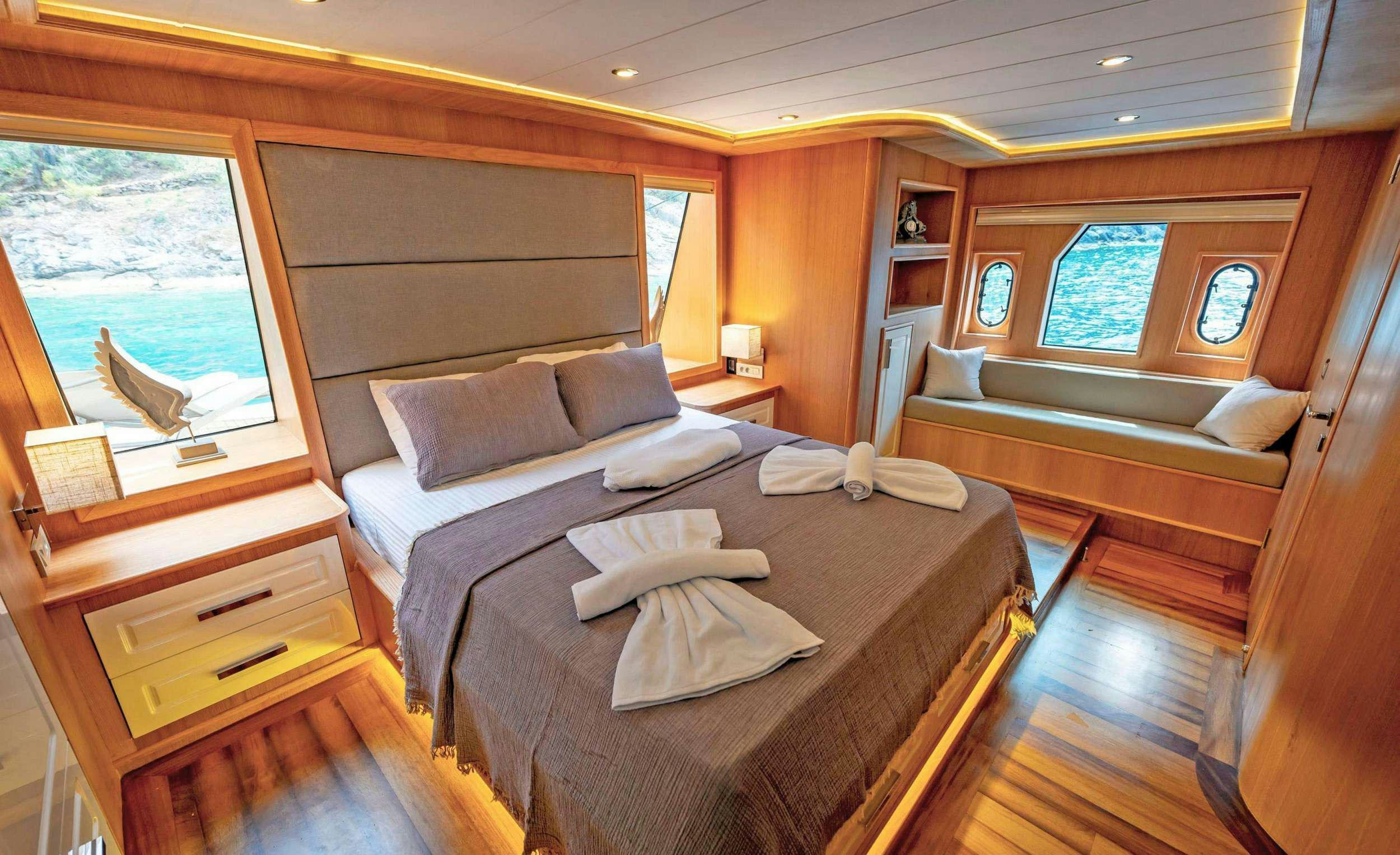 a room with a bed and a couch aboard SIMAY M Yacht for Charter