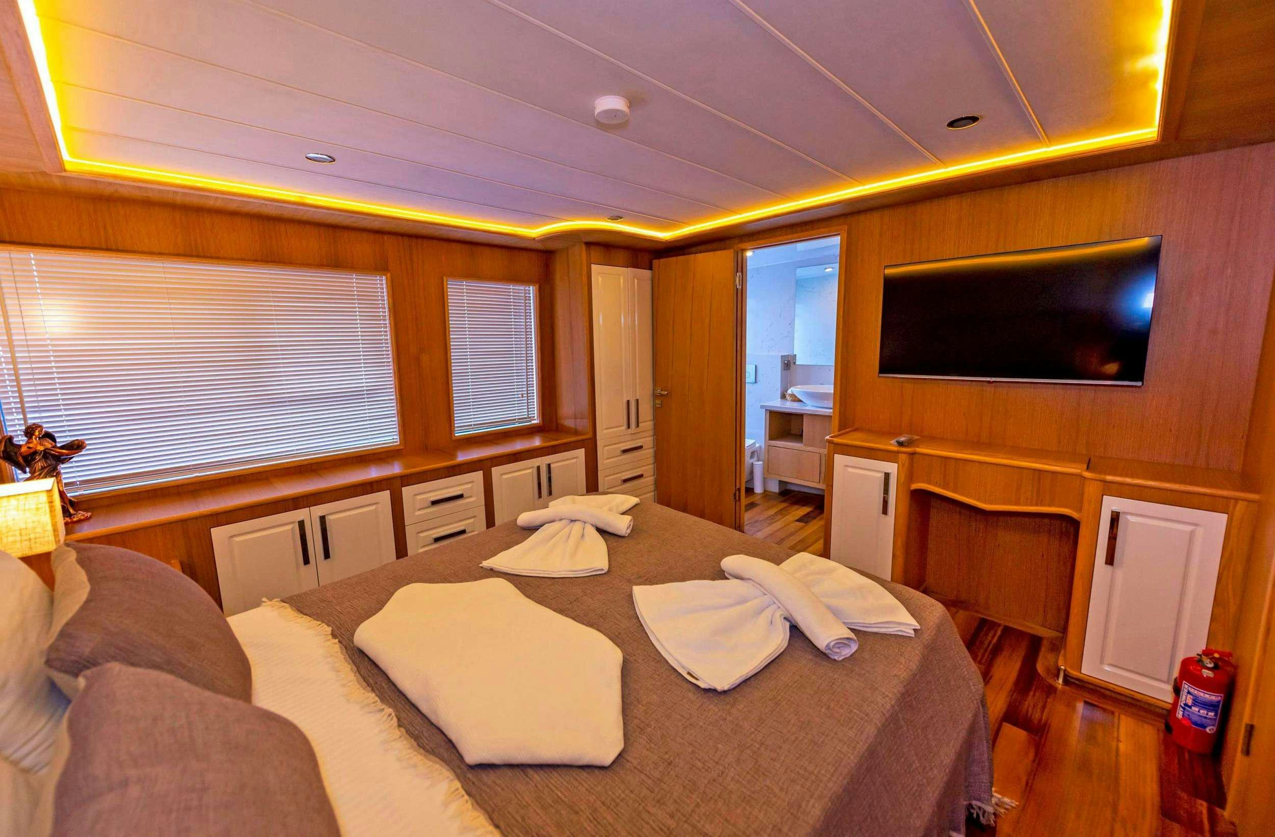 a living room with a couch and tv aboard SIMAY M Yacht for Charter