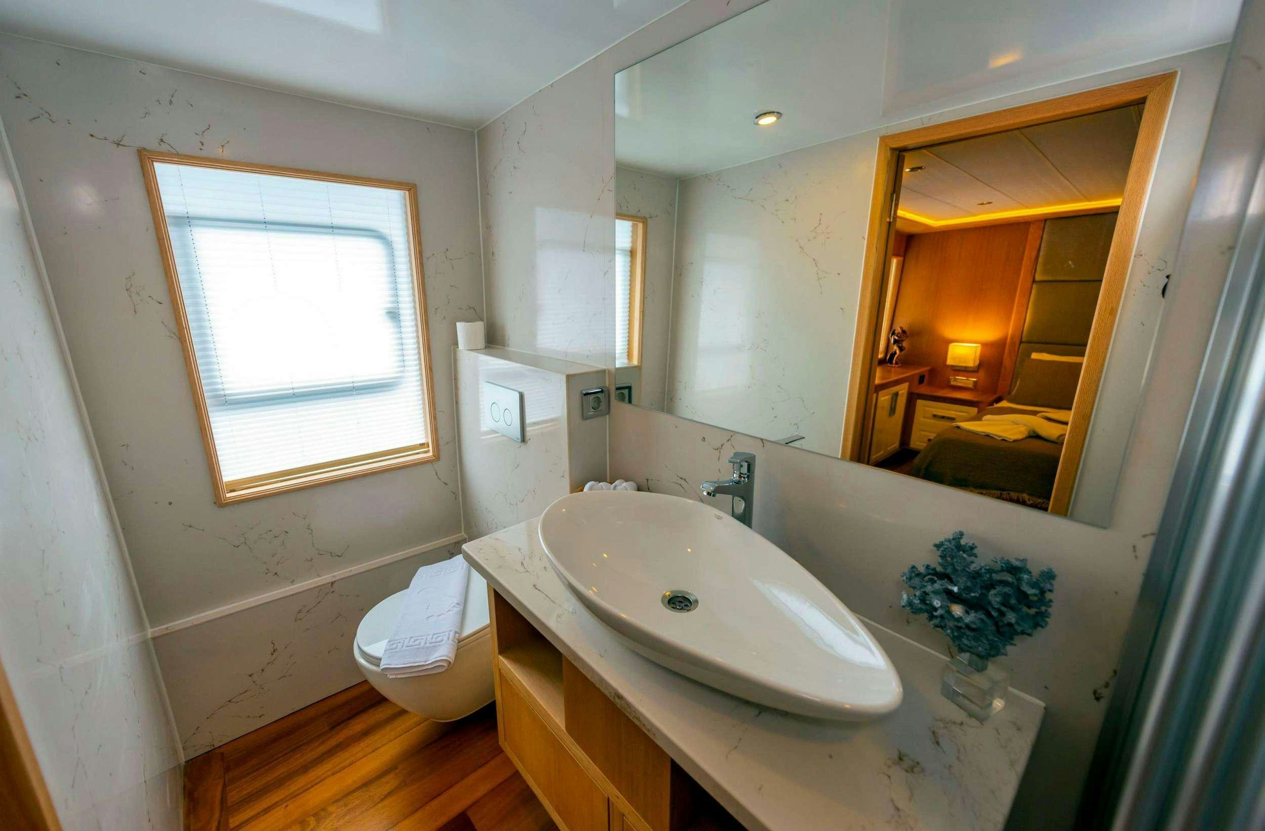 a bathroom with a sink and a mirror aboard SIMAY M Yacht for Charter