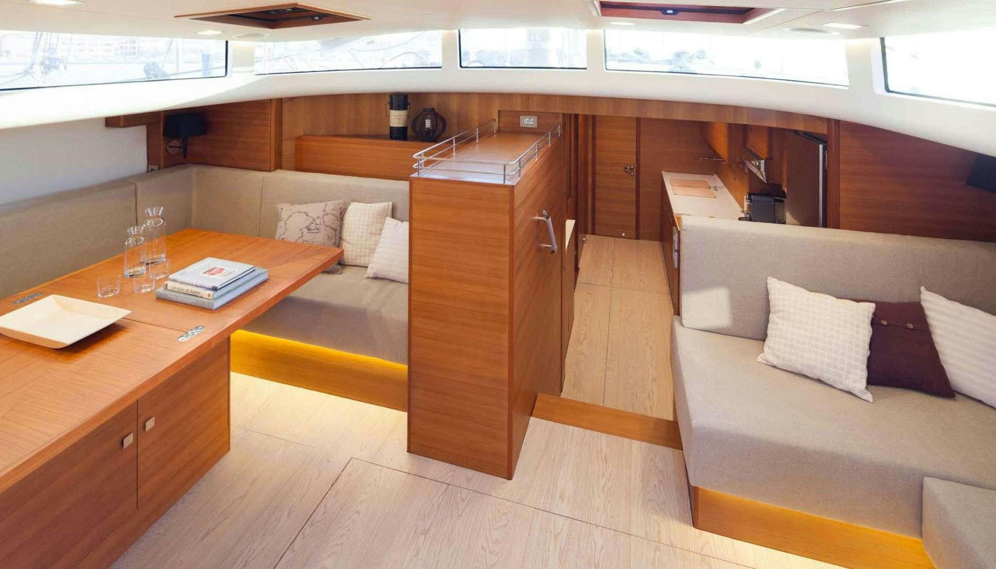 a room with a couch and a table aboard SOLARIS 72 Yacht for Charter