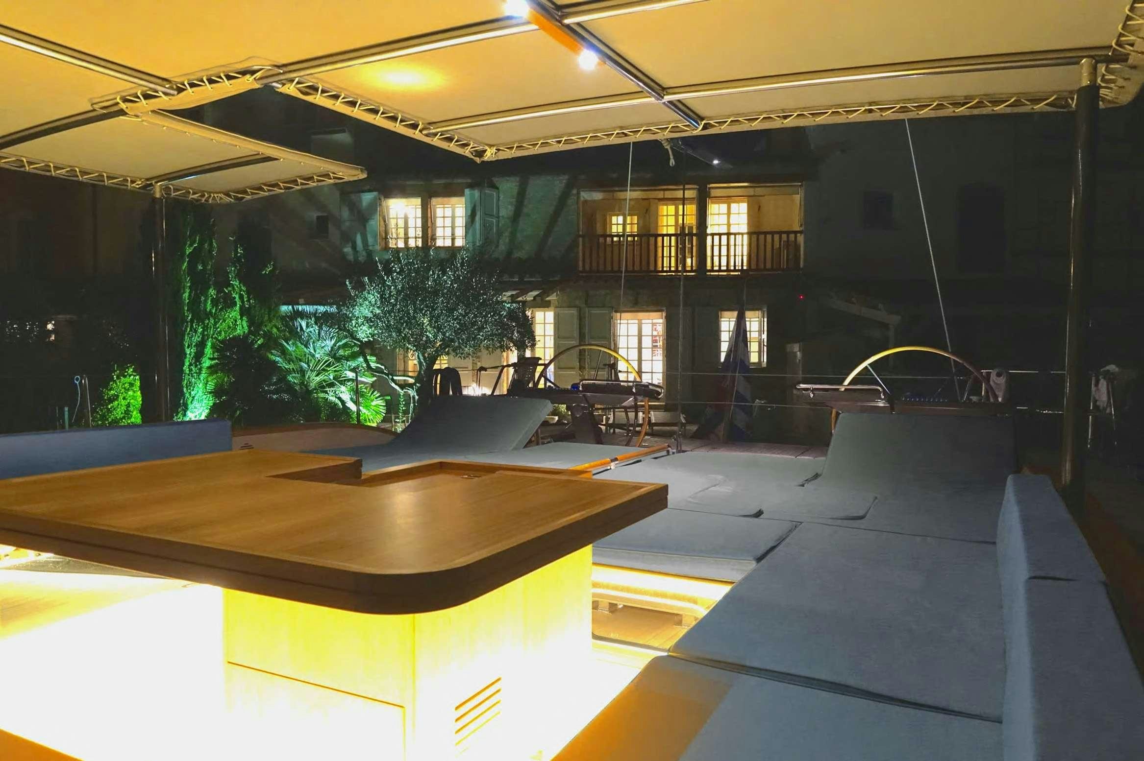 a room with a table and chairs aboard SOLARIS 72 Yacht for Charter