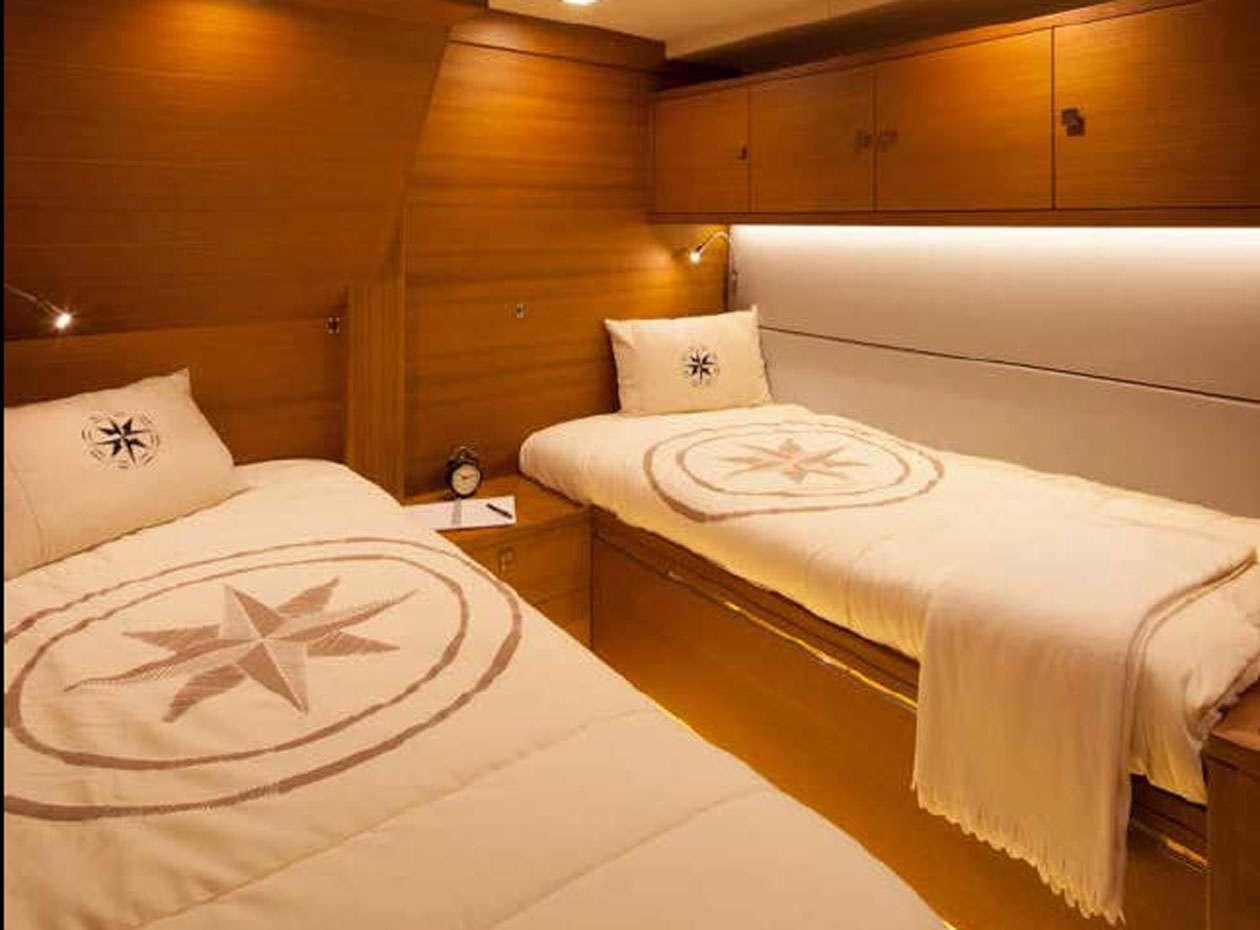a couple of beds in a room aboard SOLARIS 72 Yacht for Charter