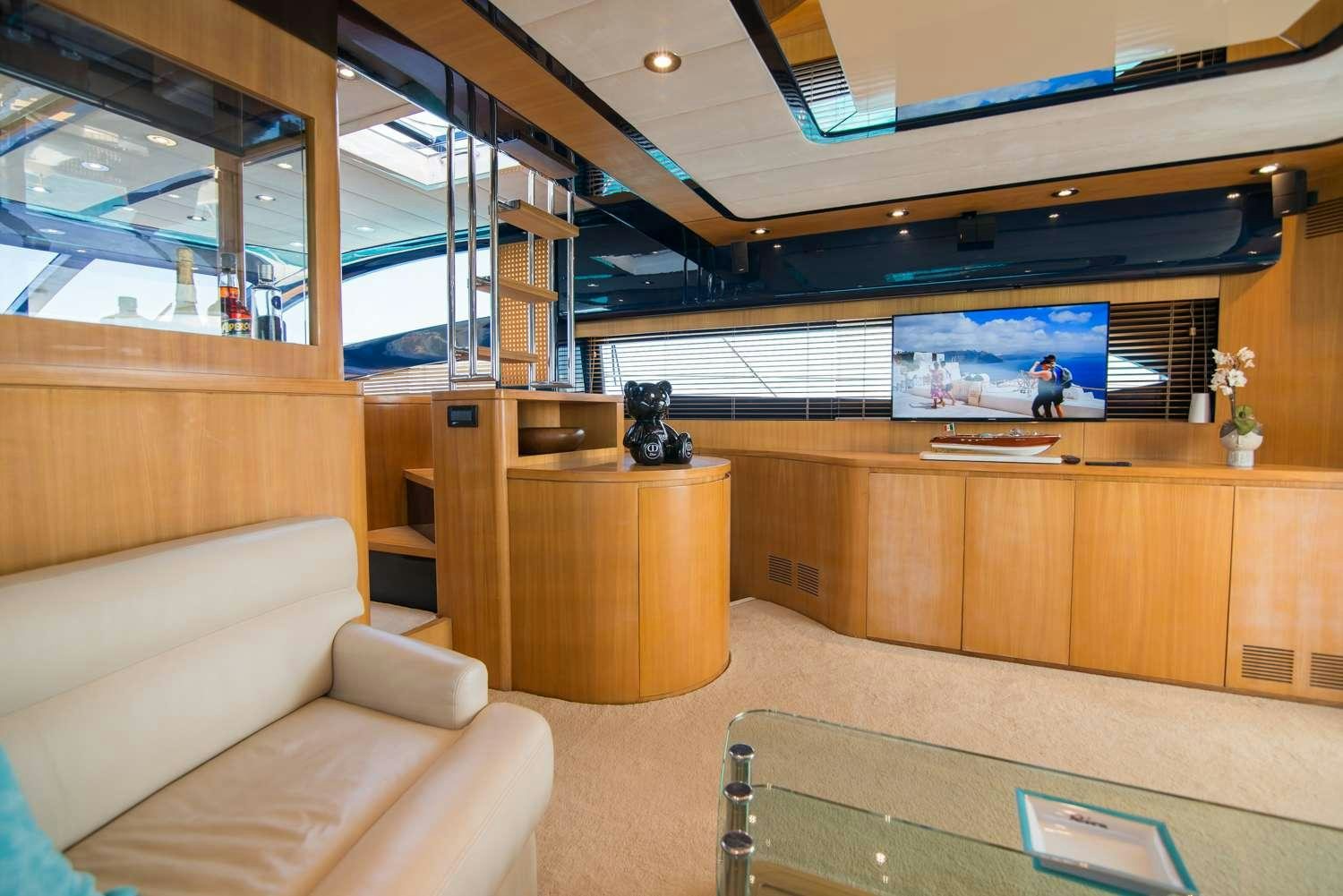 a room with a couch and a tv aboard ANTAMAR II Yacht for Charter