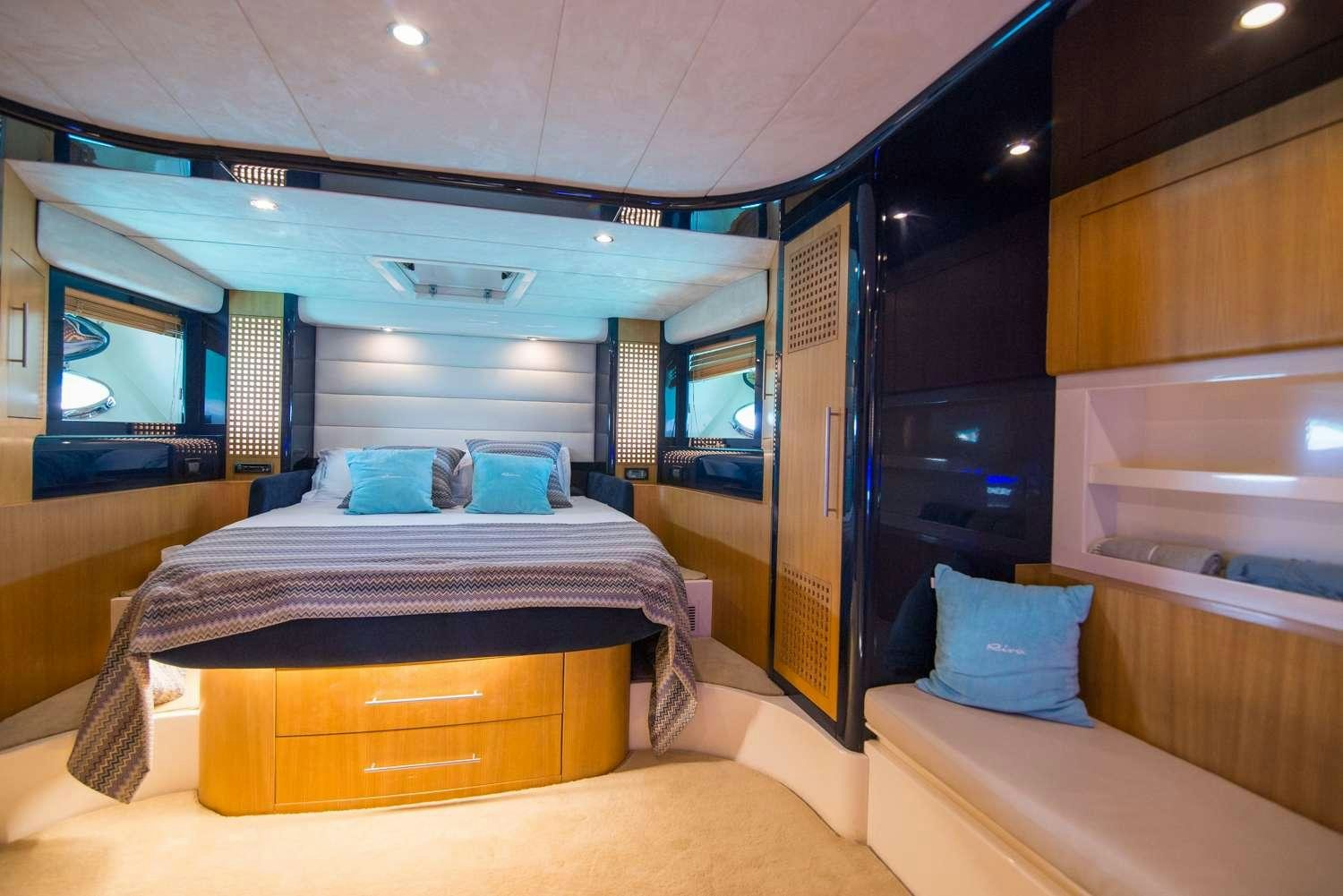 a bedroom with a bed and a tv aboard ANTAMAR II Yacht for Charter