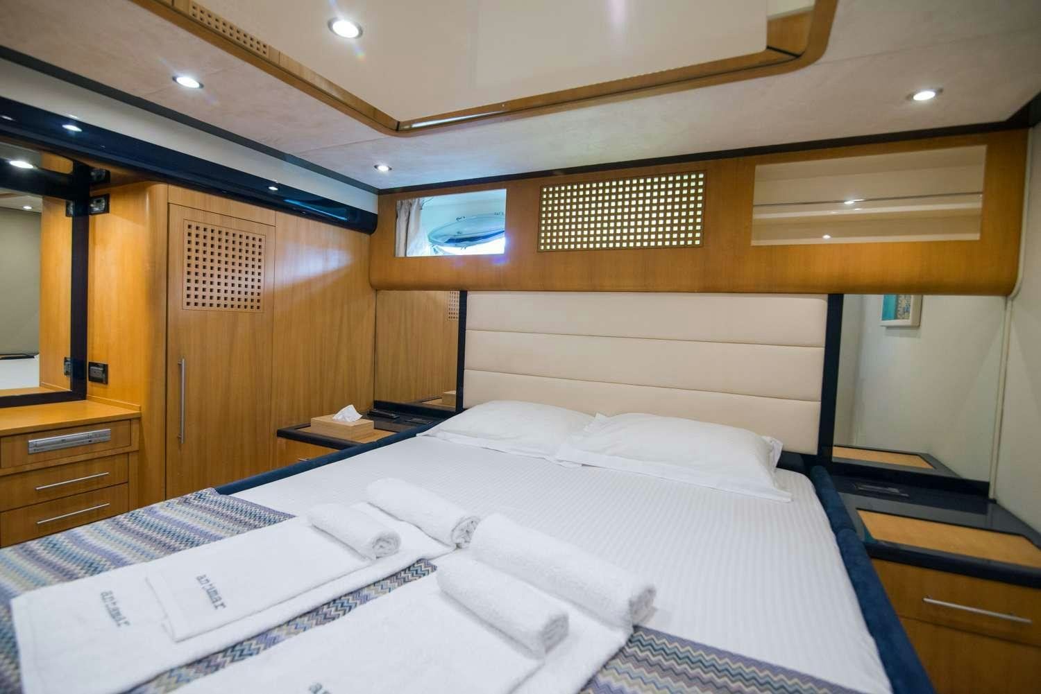 a room with a bed and a desk aboard ANTAMAR II Yacht for Charter