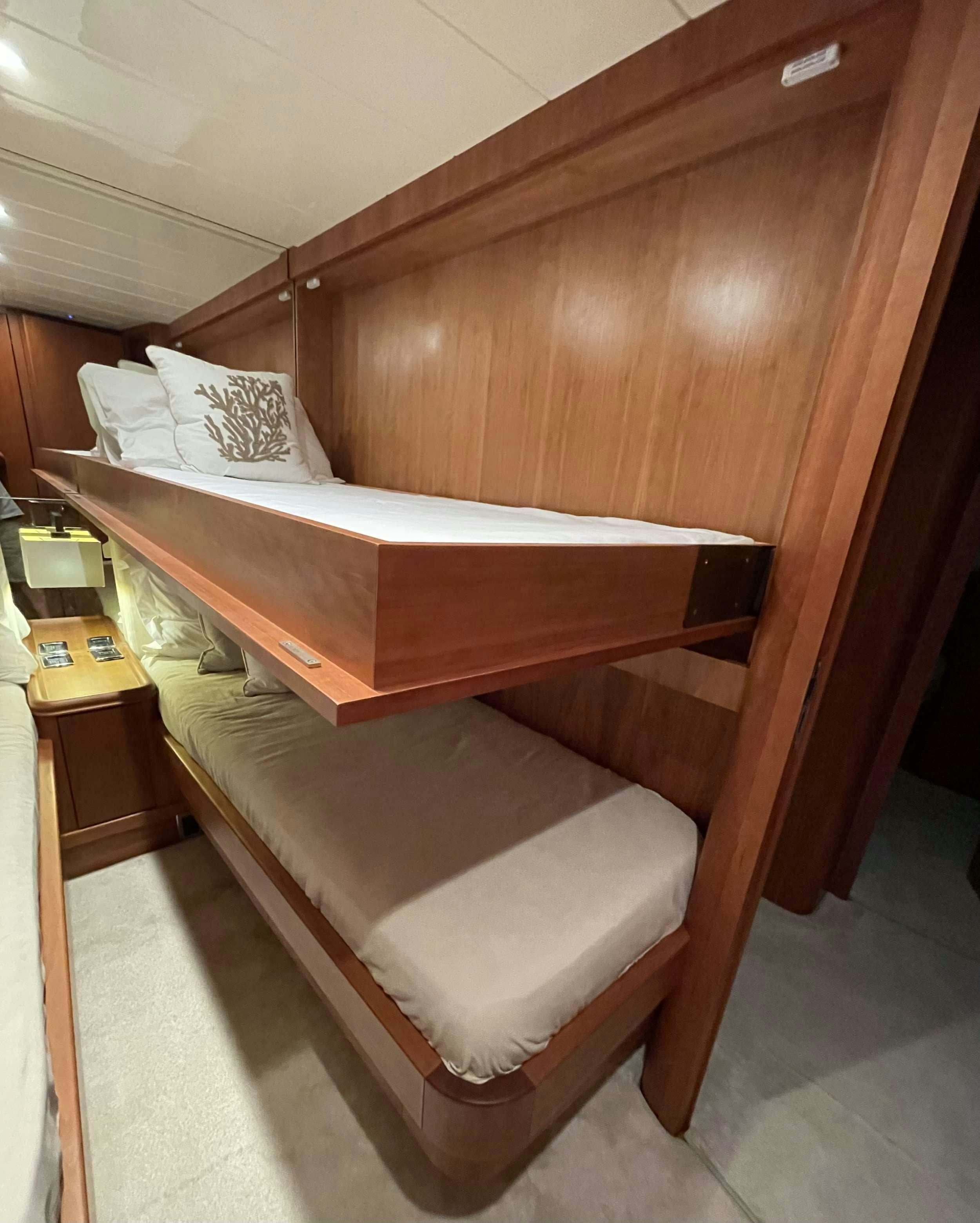 a bed with a wooden frame aboard BIANCA II Yacht for Charter