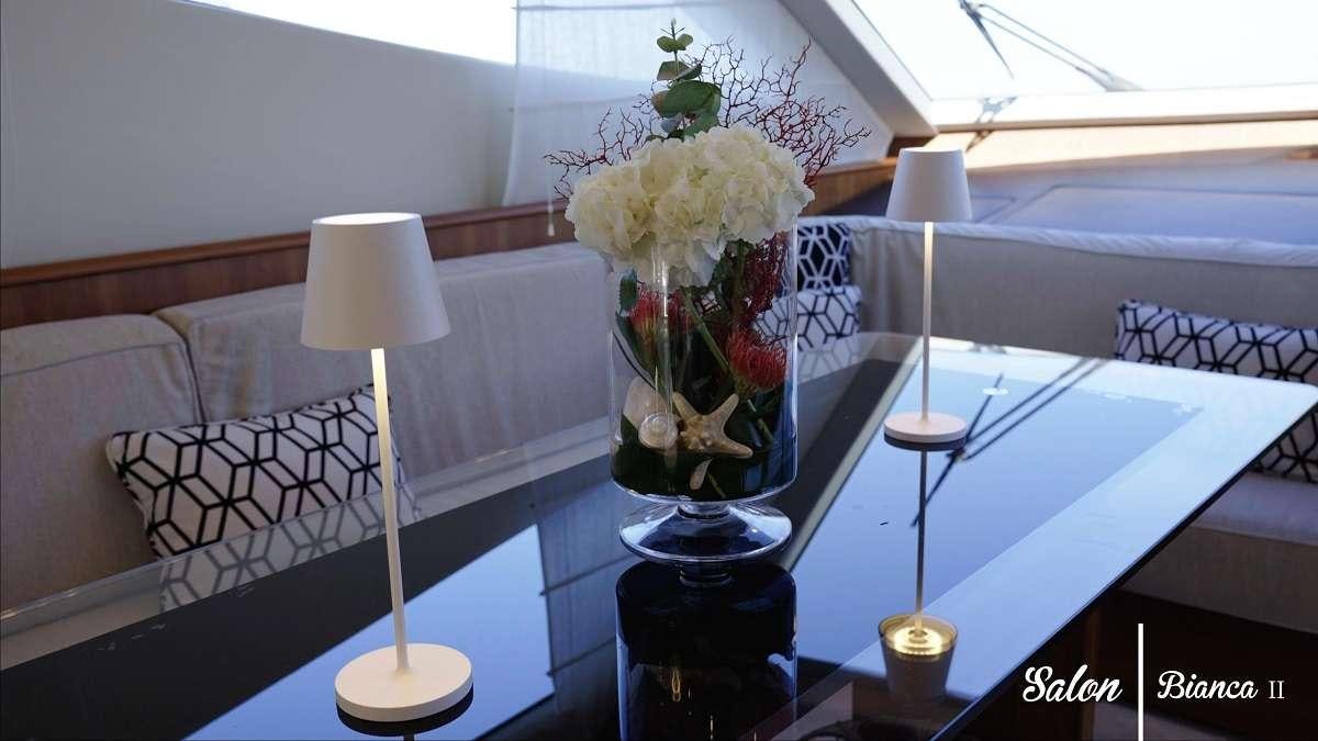 a vase of flowers on a table aboard BIANCA II Yacht for Charter