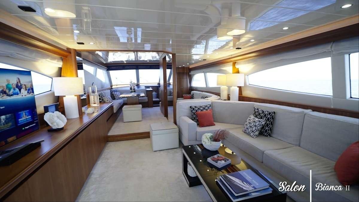 a living room with a large window aboard BIANCA II Yacht for Charter