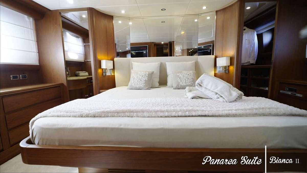 a bed with white sheets aboard BIANCA II Yacht for Charter