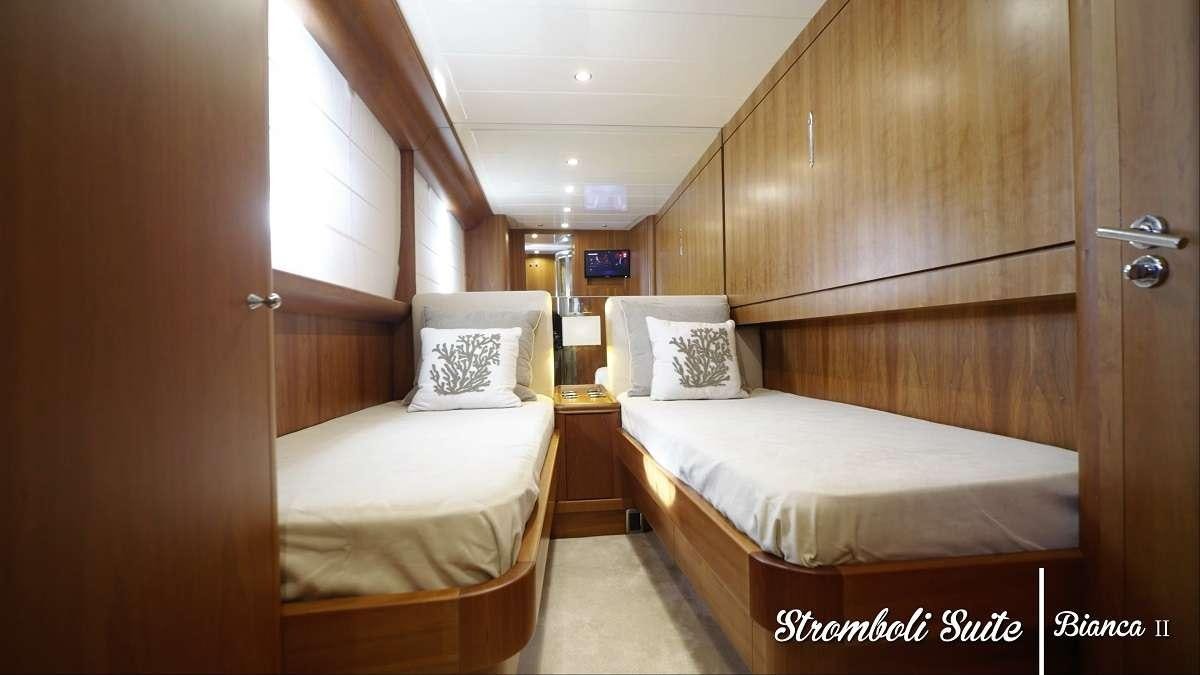 a couple of beds in a room aboard BIANCA II Yacht for Charter
