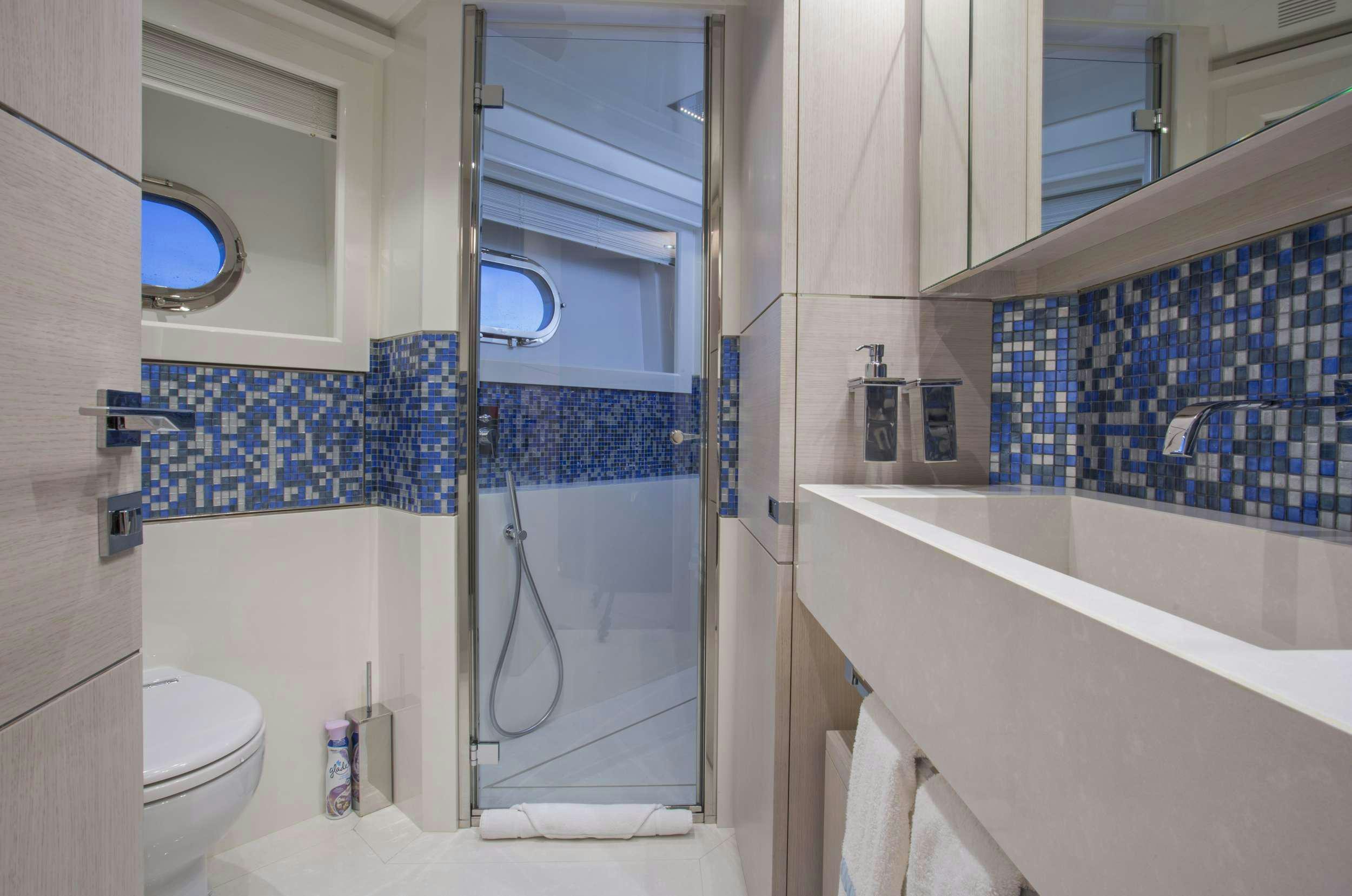 a bathroom with a tub and toilet aboard ALANDREA Yacht for Charter