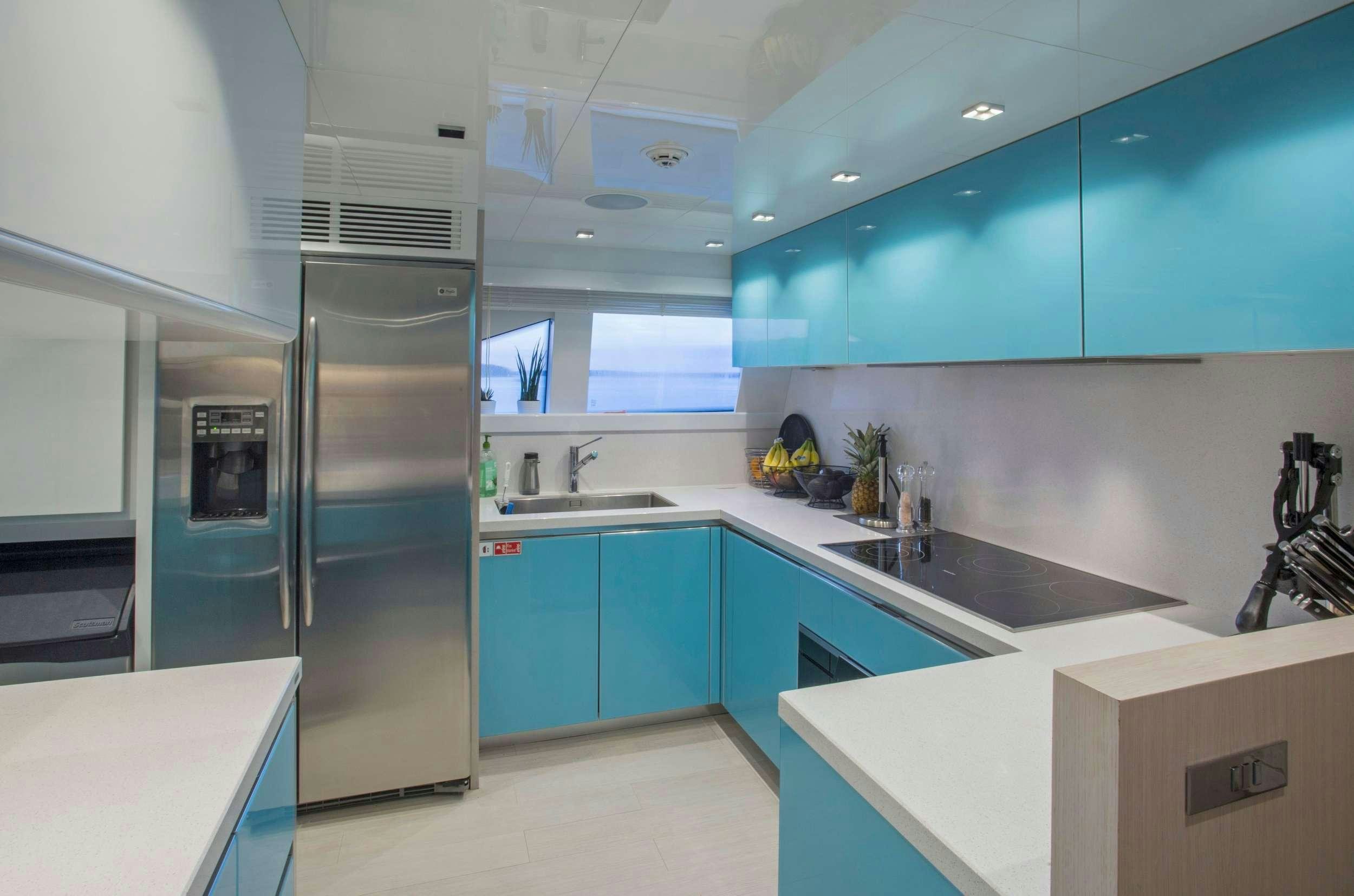 a kitchen with a stainless steel refrigerator aboard ALANDREA Yacht for Charter