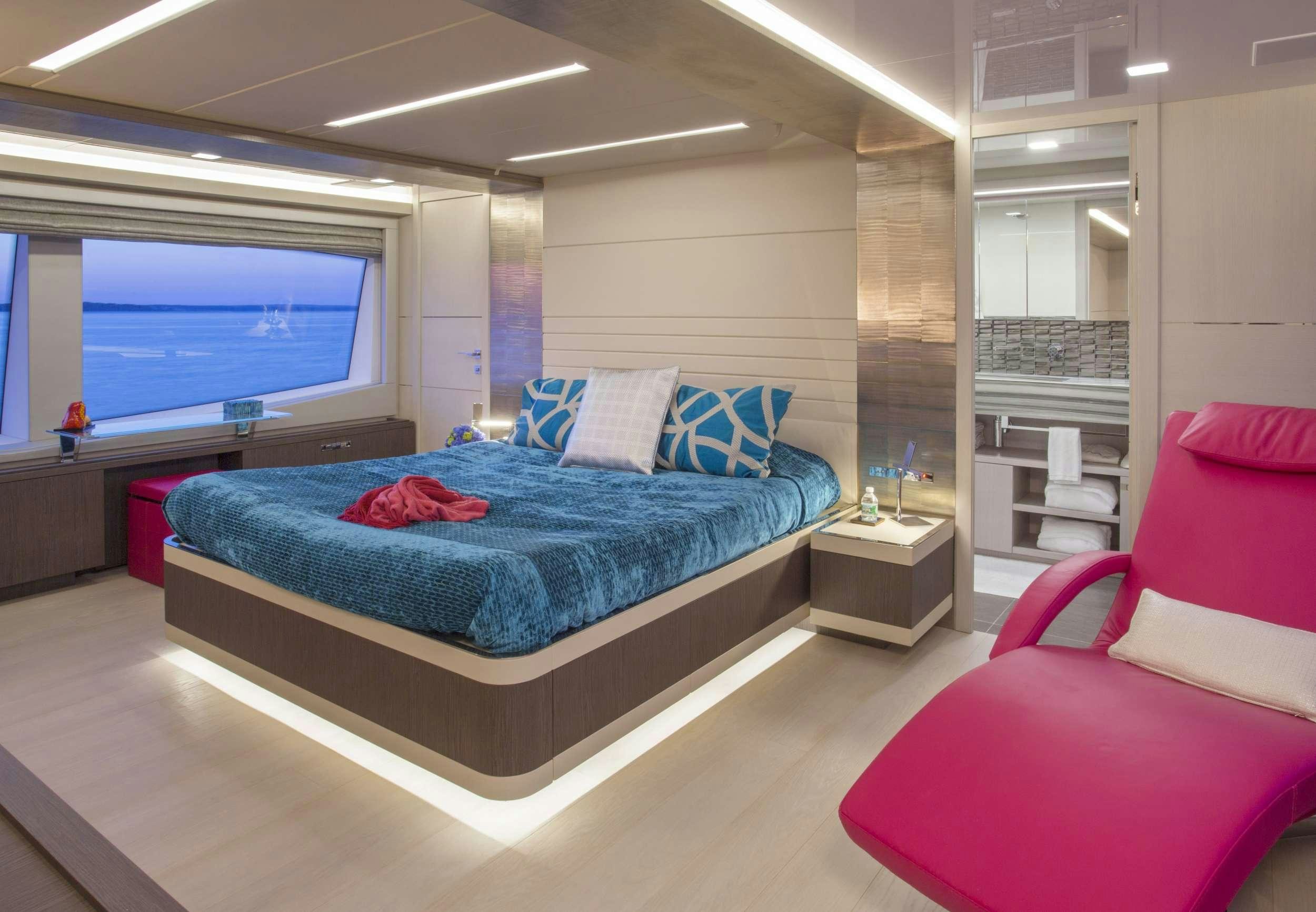 a bedroom with a bed and a window aboard ALANDREA Yacht for Charter