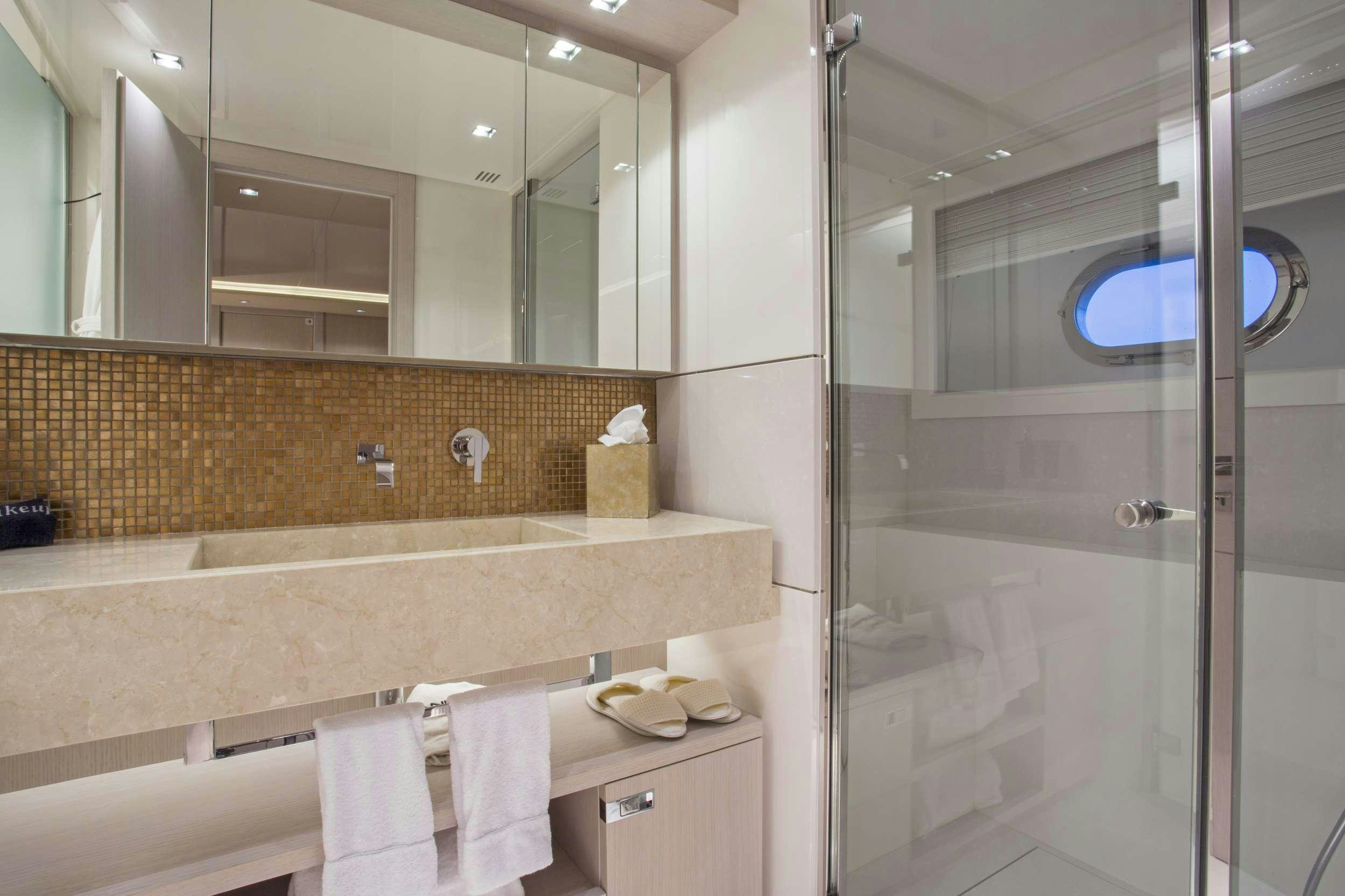 a bathroom with a glass shower aboard ALANDREA Yacht for Charter