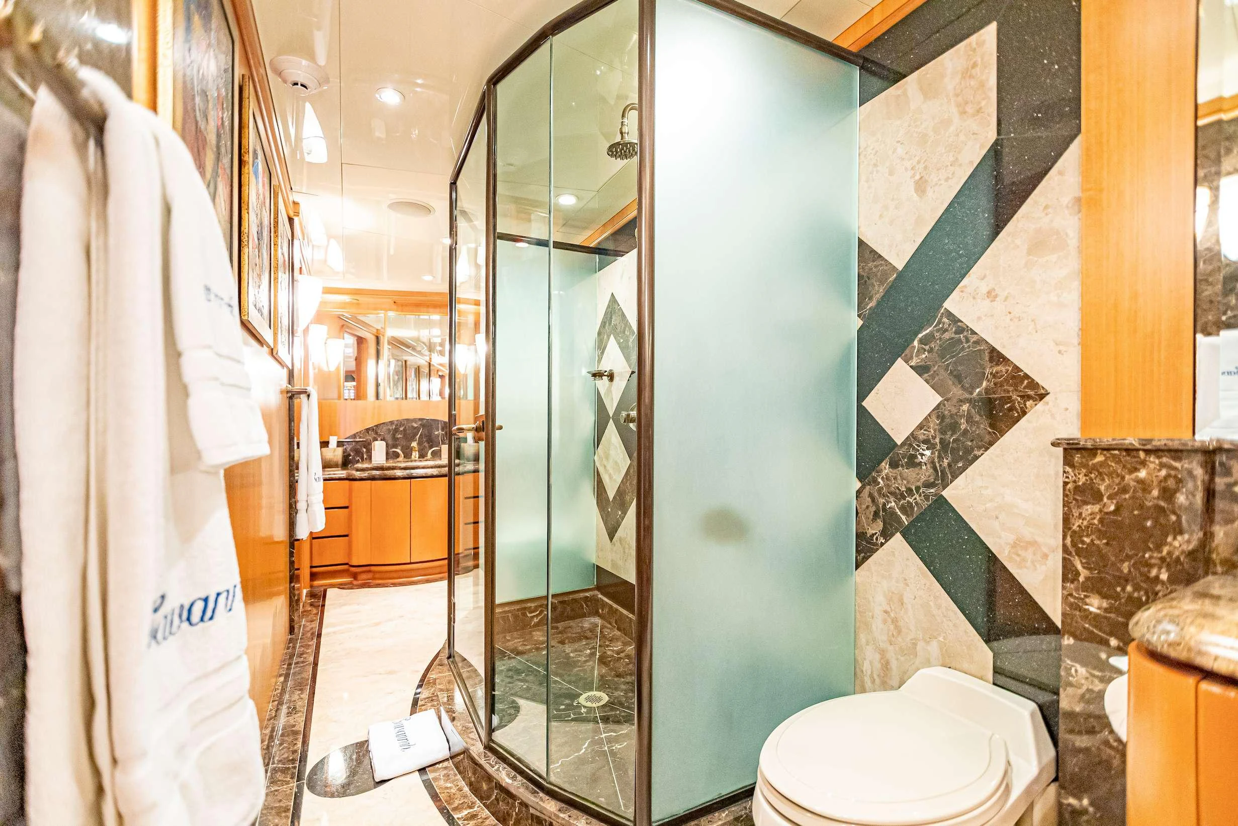 a bathroom with a glass shower aboard XOXO (118') Yacht for Charter