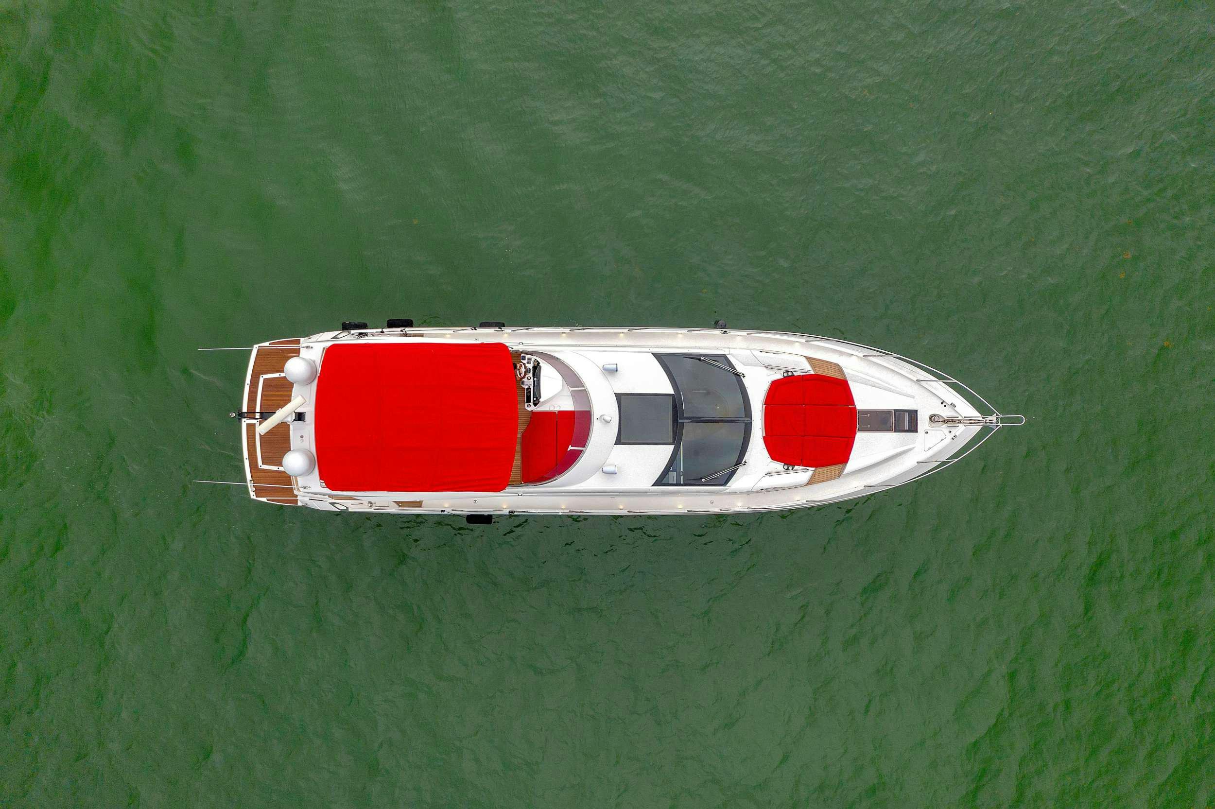a white and red boat on water aboard GEM Yacht for Charter