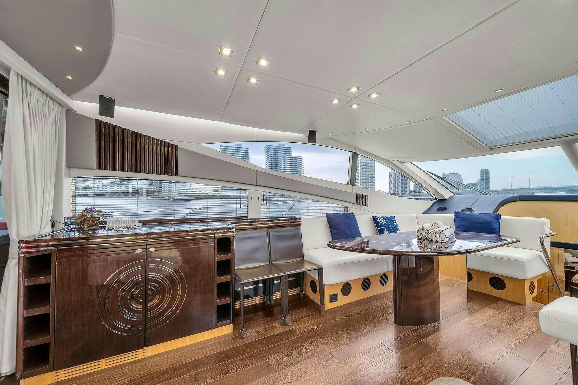 a room with a table and chairs aboard GEM Yacht for Charter