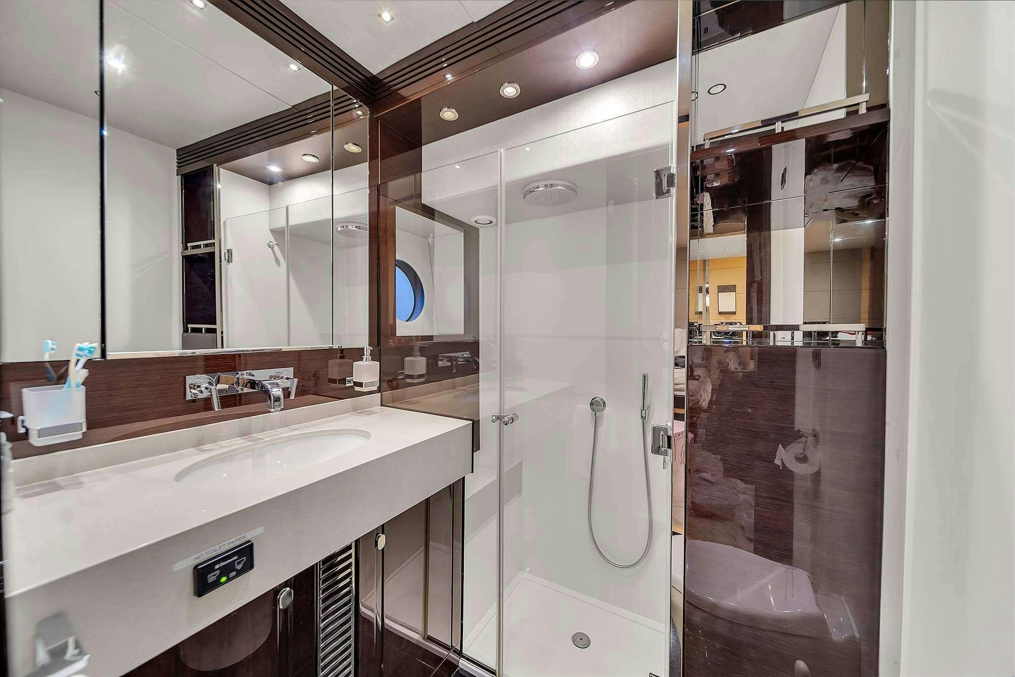 a bathroom with a shower and sink aboard GEM Yacht for Charter