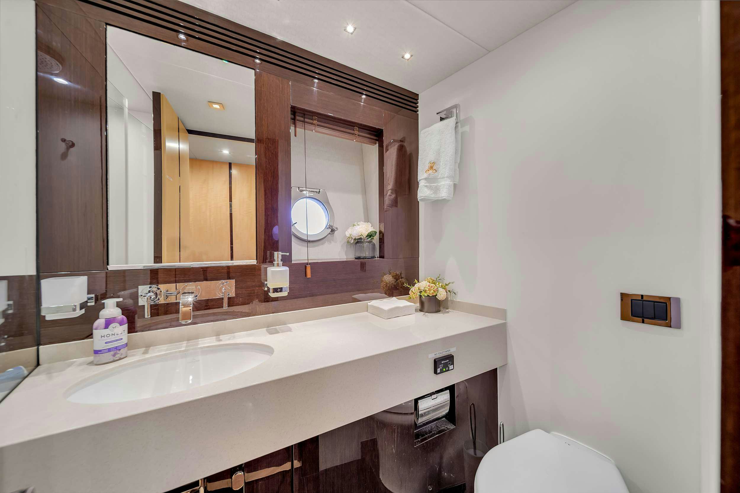 a bathroom with a large mirror aboard GEM Yacht for Charter