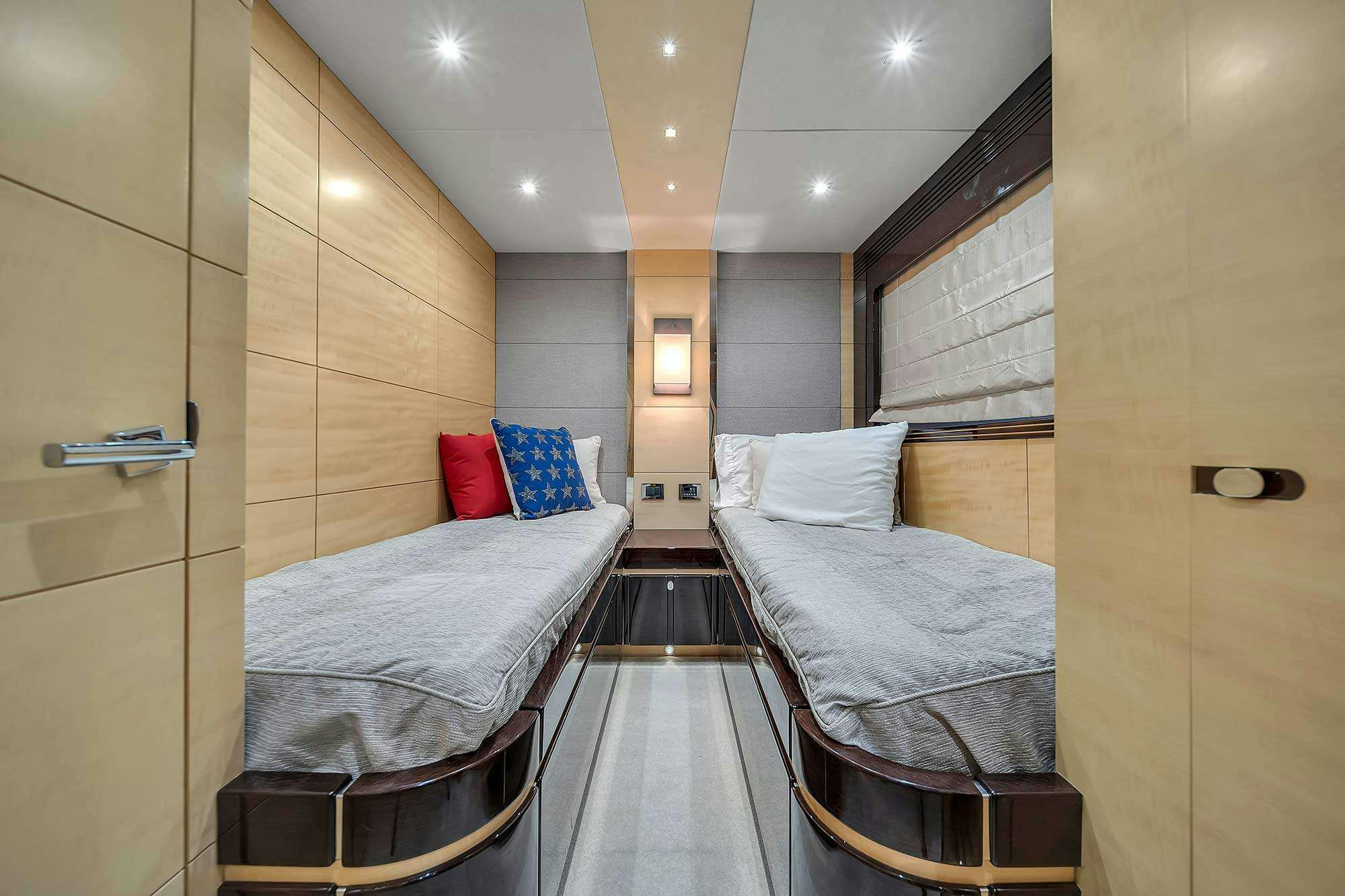 a room with a bed and a chair aboard GEM Yacht for Charter