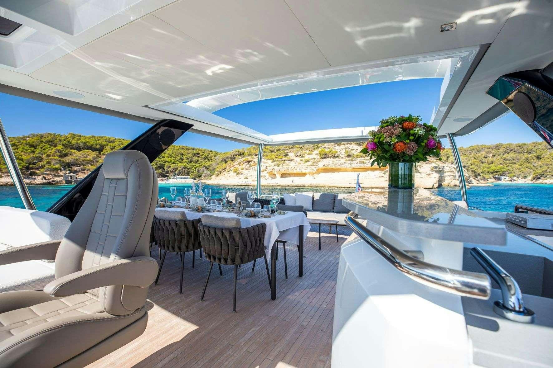 a room with a table chairs and a pool aboard SASTA Yacht for Charter