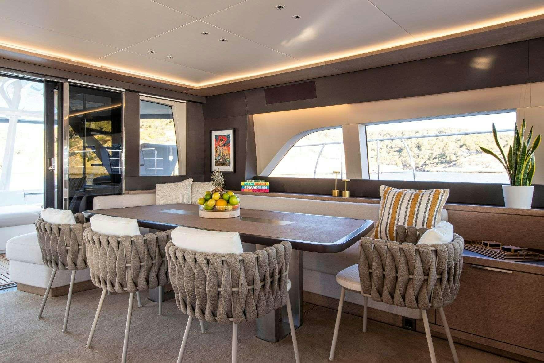 a kitchen with a table and chairs aboard SASTA Yacht for Charter