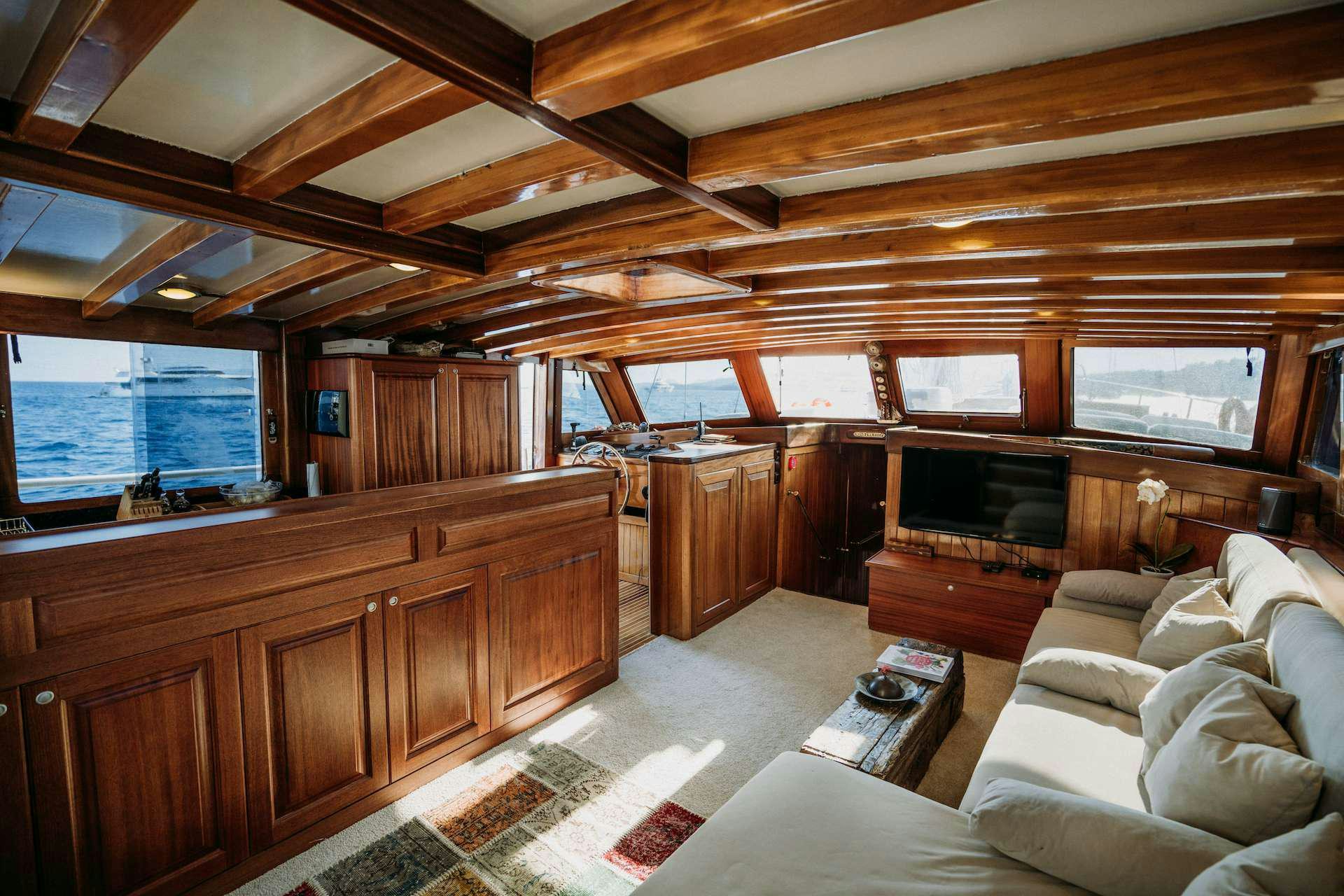a living room with a fireplace aboard BEYAZ LALE Yacht for Charter
