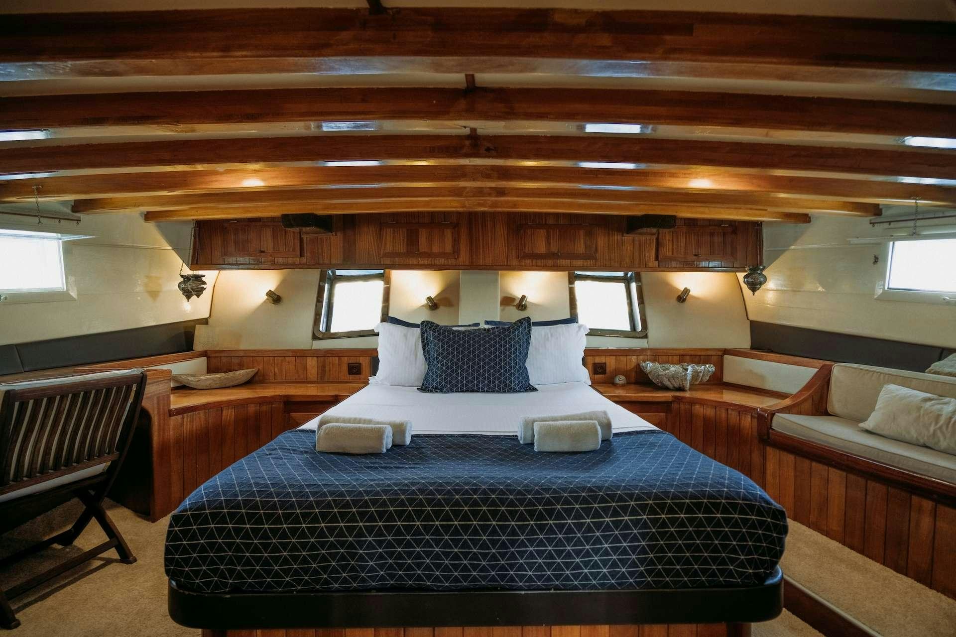 a room with a bed and a couch aboard BEYAZ LALE Yacht for Charter