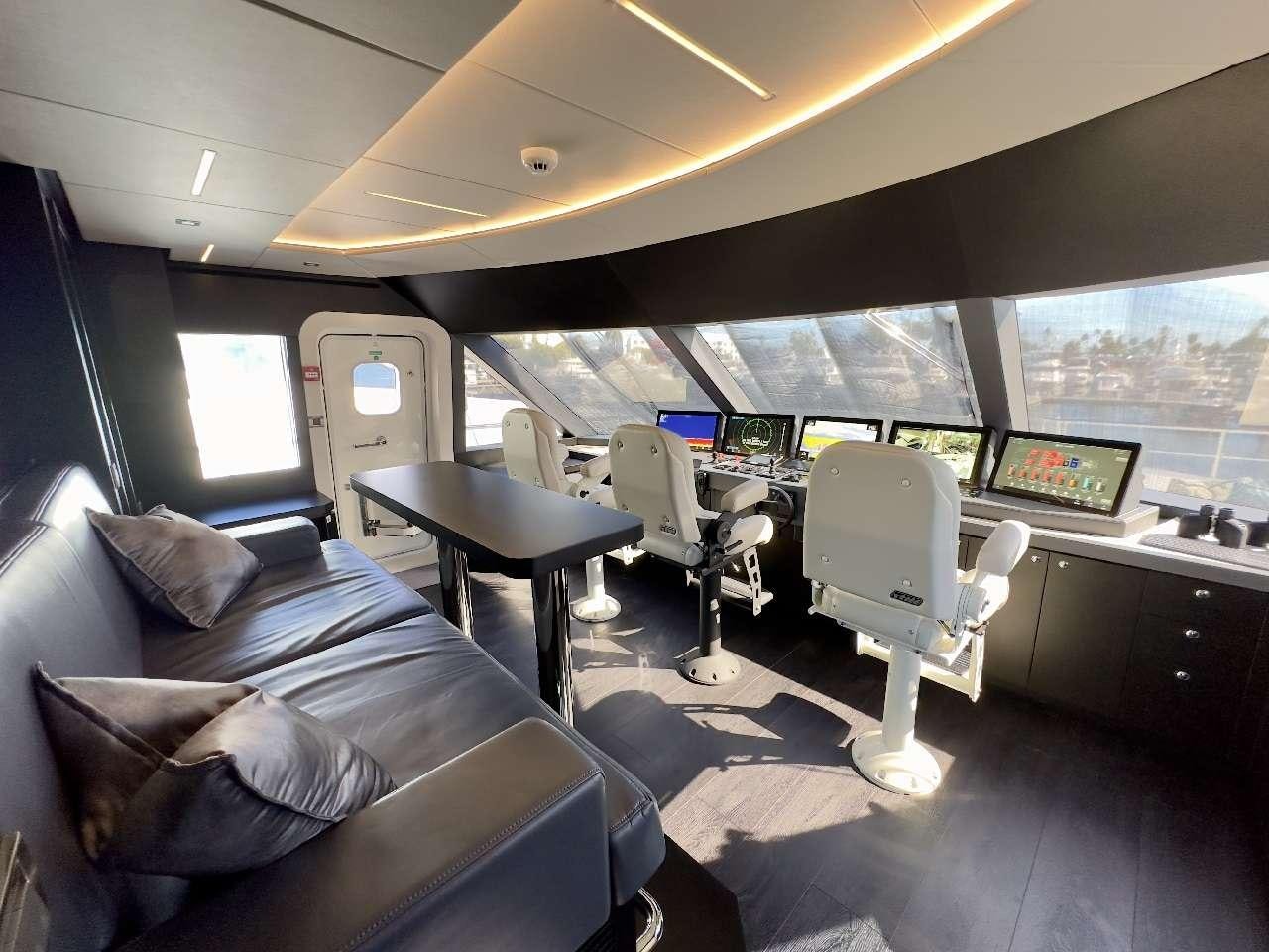 a room with a couch and a table and chairs aboard ROMEO FOXTROT Yacht for Charter