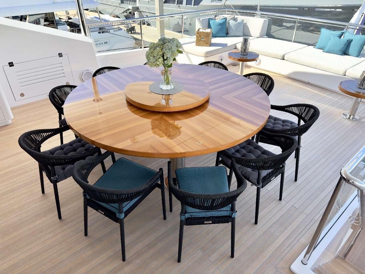a table with chairs around it aboard ROMEO FOXTROT Yacht for Charter