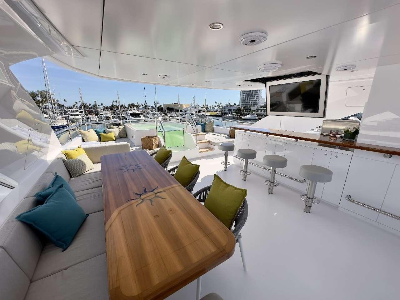 a room with a couch and a tv aboard ROMEO FOXTROT Yacht for Charter