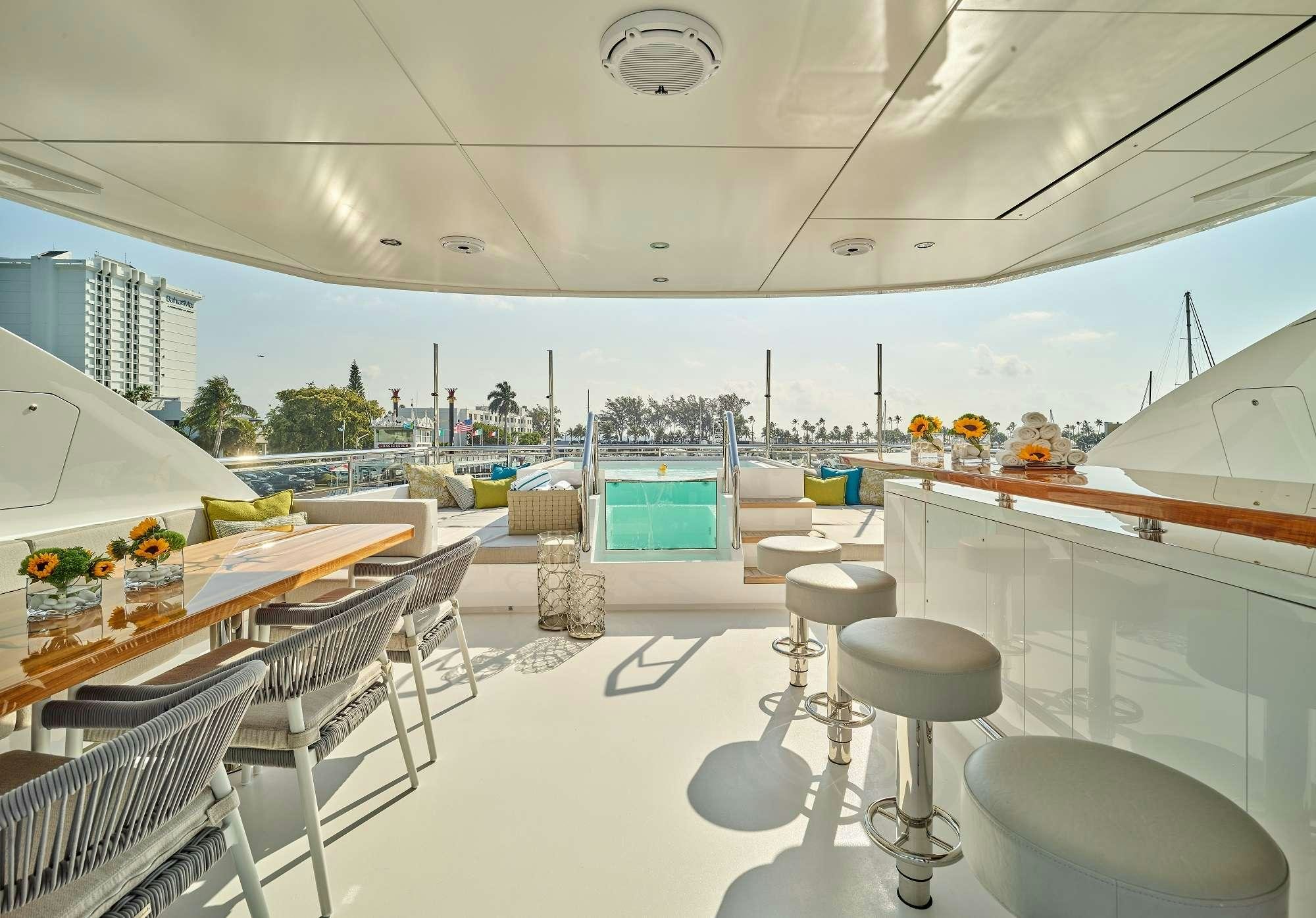 a room with tables and chairs aboard ROMEO FOXTROT Yacht for Charter