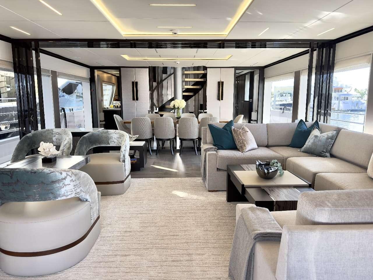 a living room with a large window aboard ROMEO FOXTROT Yacht for Charter