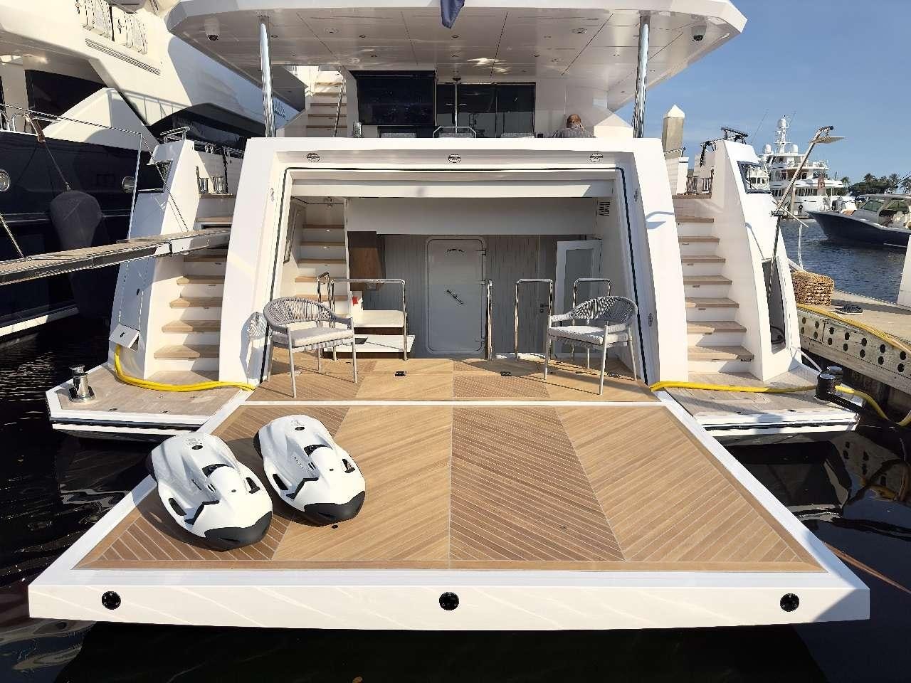 a deck with a table and chairs on it aboard ROMEO FOXTROT Yacht for Charter