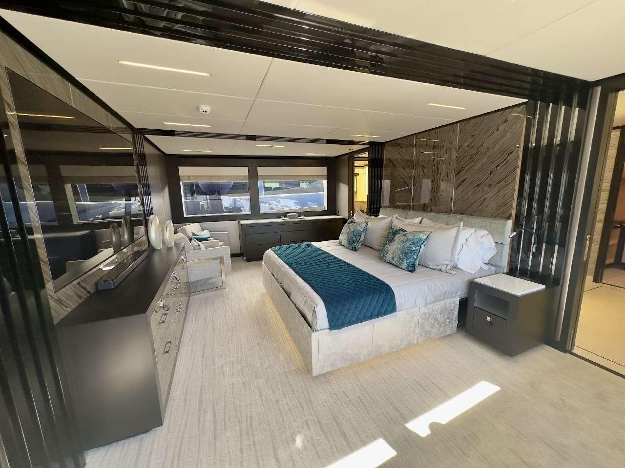 a room with a bed and a window aboard ROMEO FOXTROT Yacht for Charter