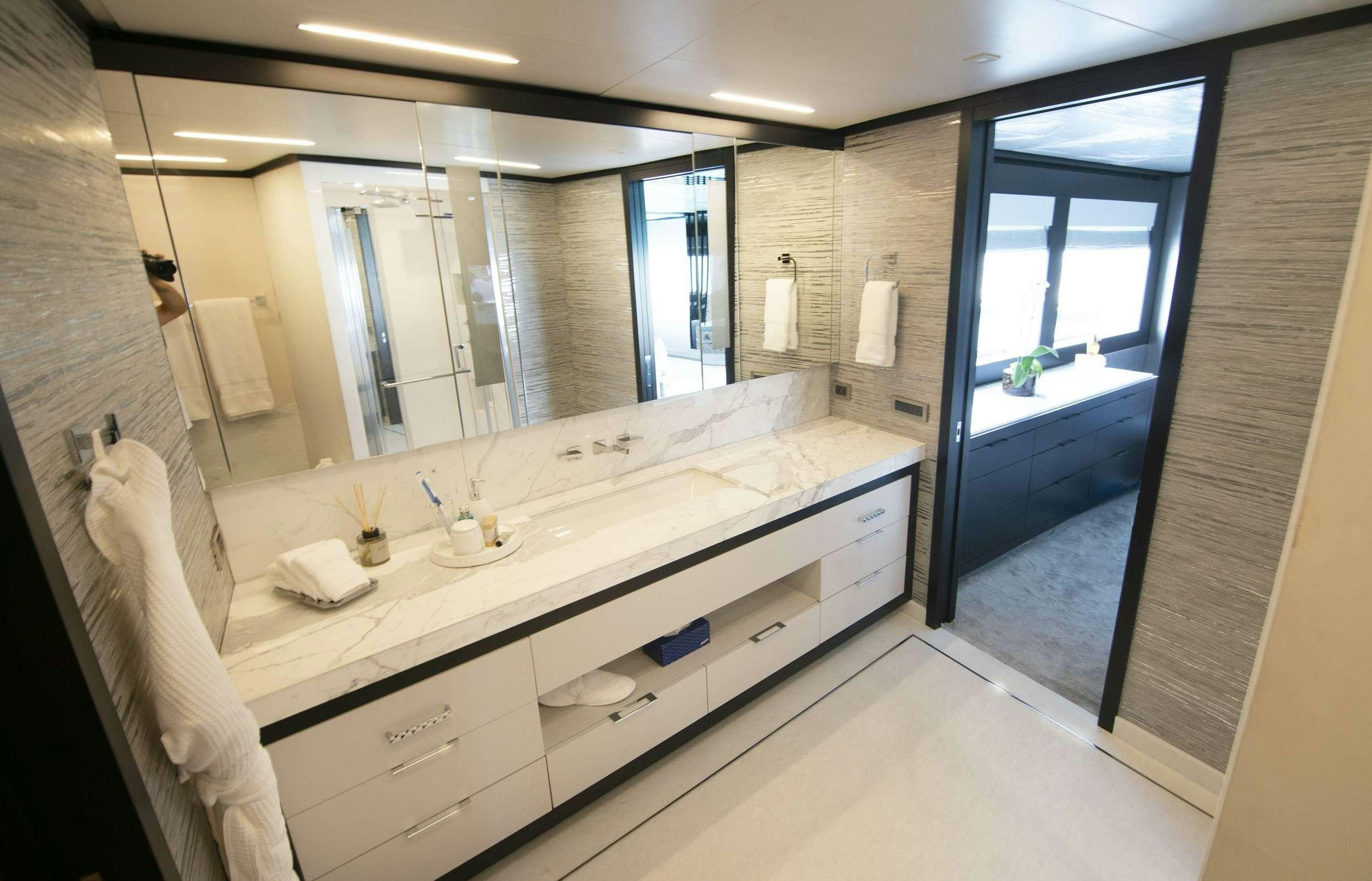 a bathroom with a large mirror aboard ROMEO FOXTROT Yacht for Charter