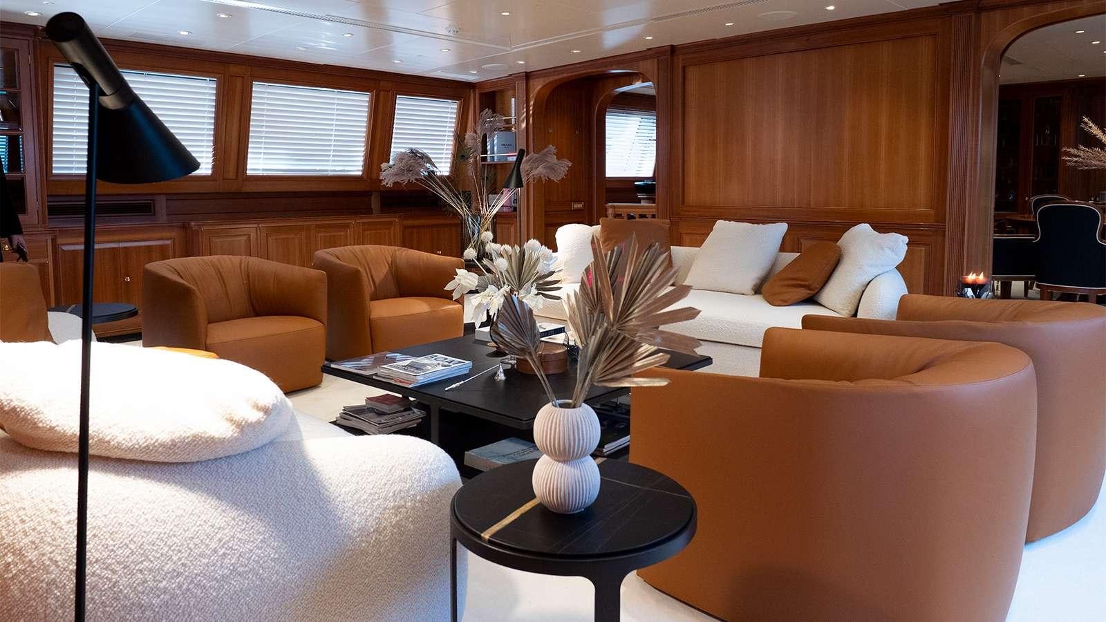 a living room with a vase of flowers on a table aboard ALMYRA II Yacht for Charter
