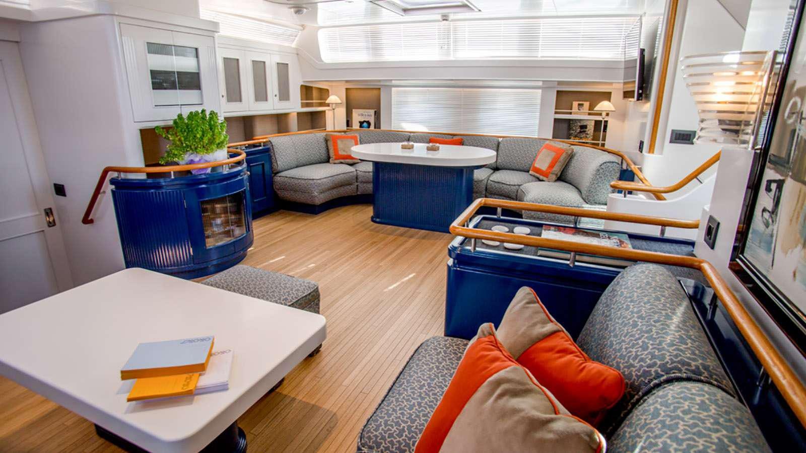 a living room with a couch and a table aboard AFAET Yacht for Charter