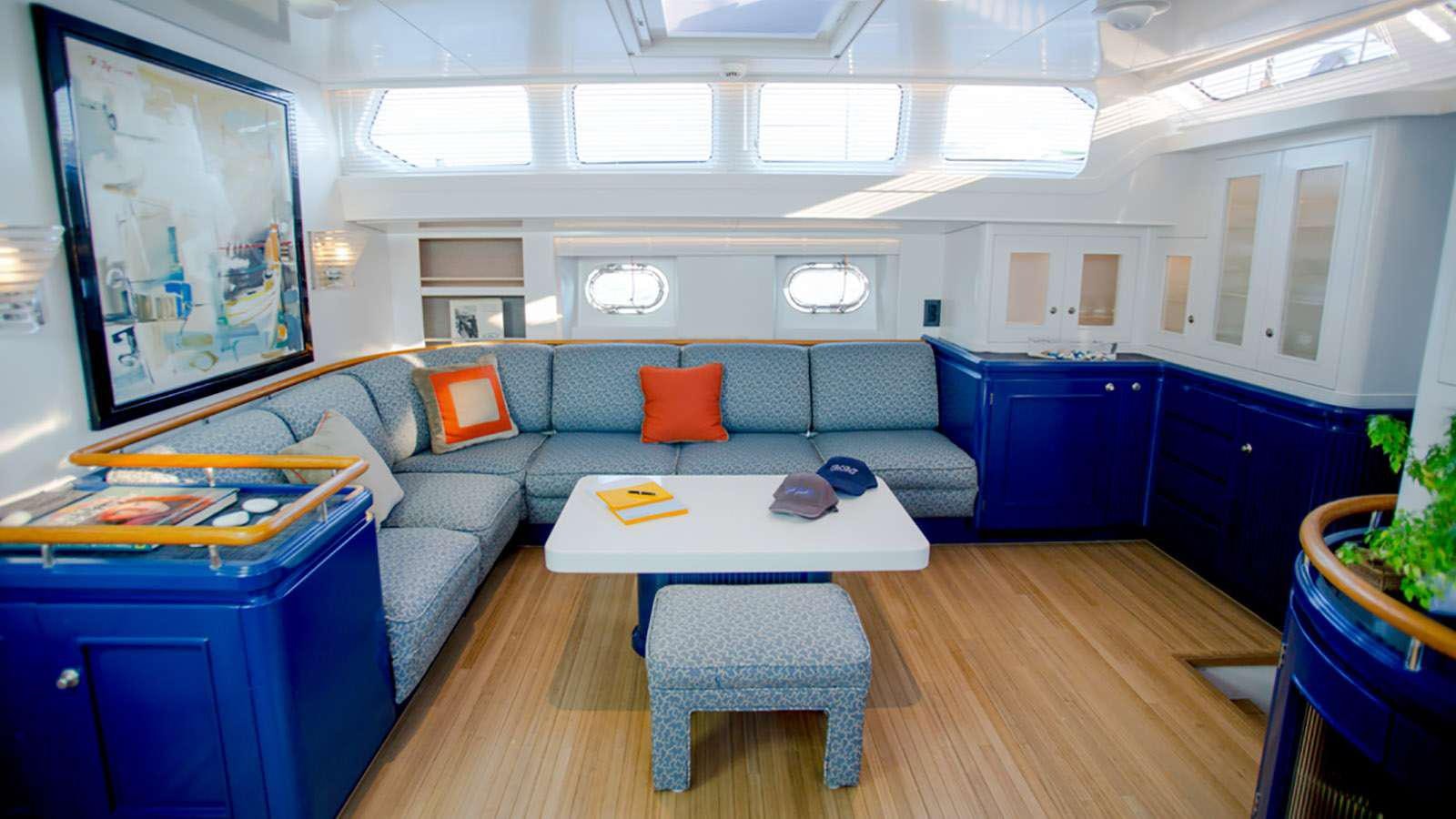 a living room with a couch and a table aboard AFAET Yacht for Charter