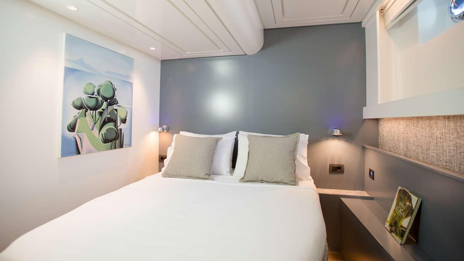 a bed with white sheets aboard AFAET Yacht for Charter