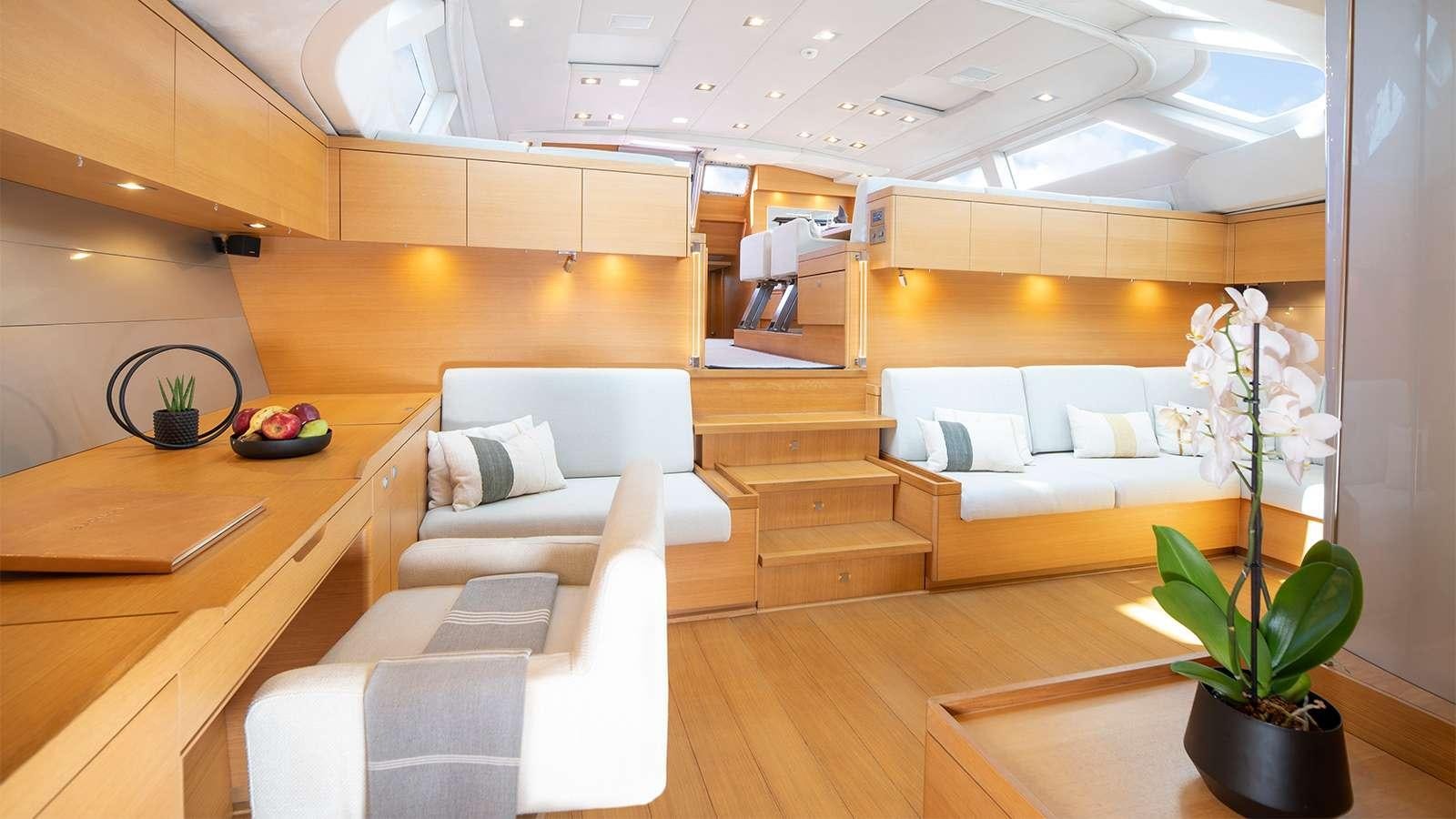 a room with a couch and a table and a plant aboard BLACK LION Yacht for Charter