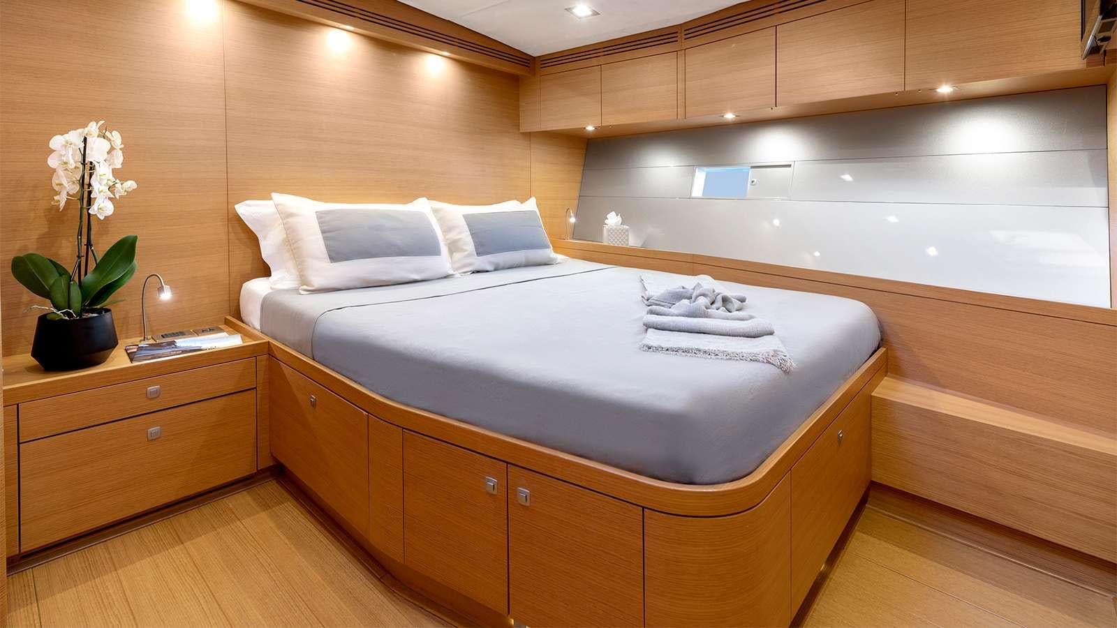 a bed with white sheets aboard BLACK LION Yacht for Charter