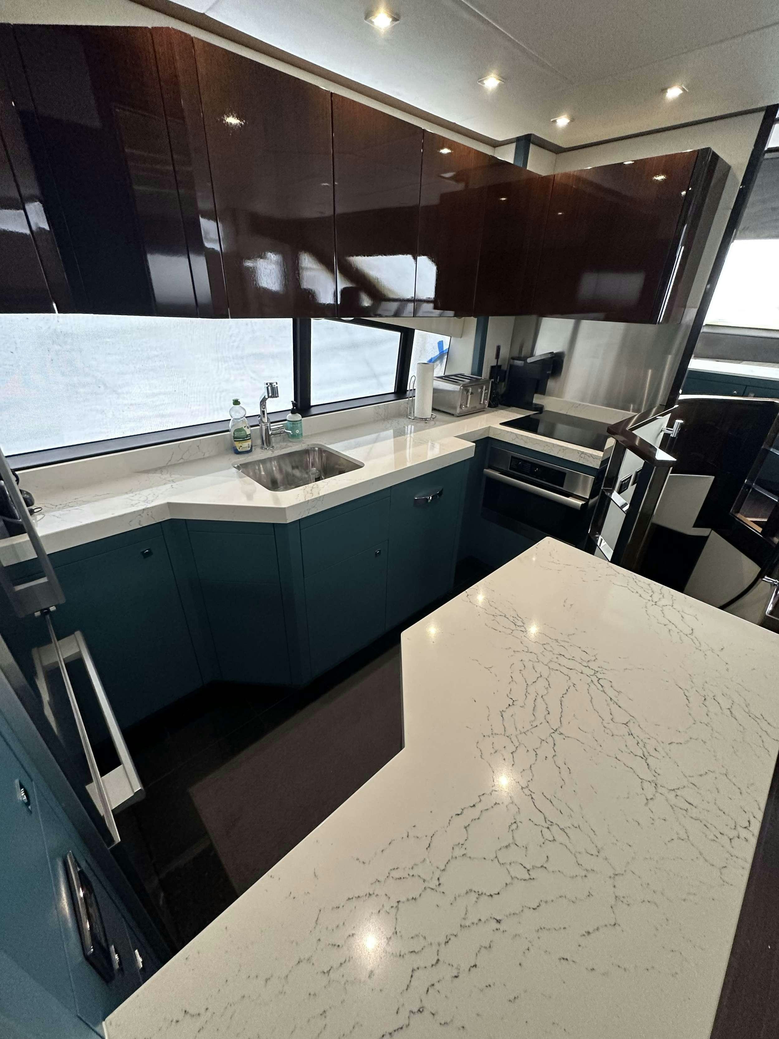 a kitchen with a large island aboard IT'S ENOUGH Yacht for Charter