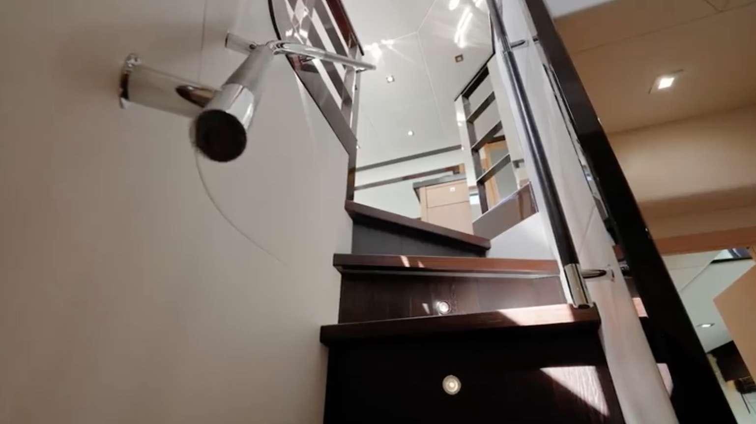 a staircase with a light aboard IT'S ENOUGH Yacht for Charter